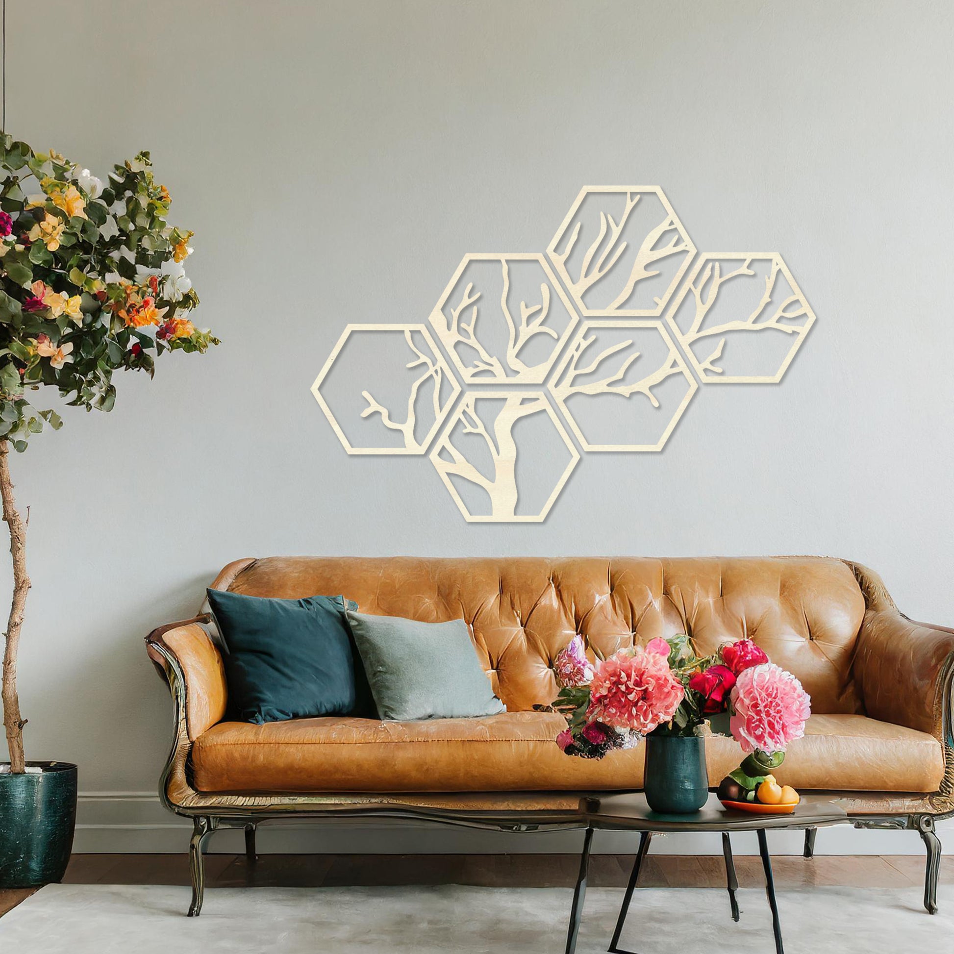 Wooden wall art showcasing a hexagonal pattern with an intricate tree branch design. Mounted on a neutral wall in a modern room decor, this geometric piece combines nature and contemporary artistry, creating a visually engaging focal point.