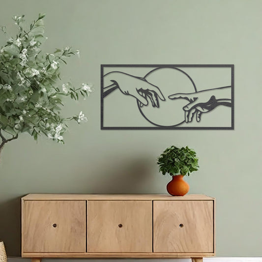 Wooden wall art featuring a minimalist depiction of two hands reaching out towards each other, framed by a circular design. Mounted on a neutral wall within modern room decor, this piece adds an artistic and meaningful touch to any space.