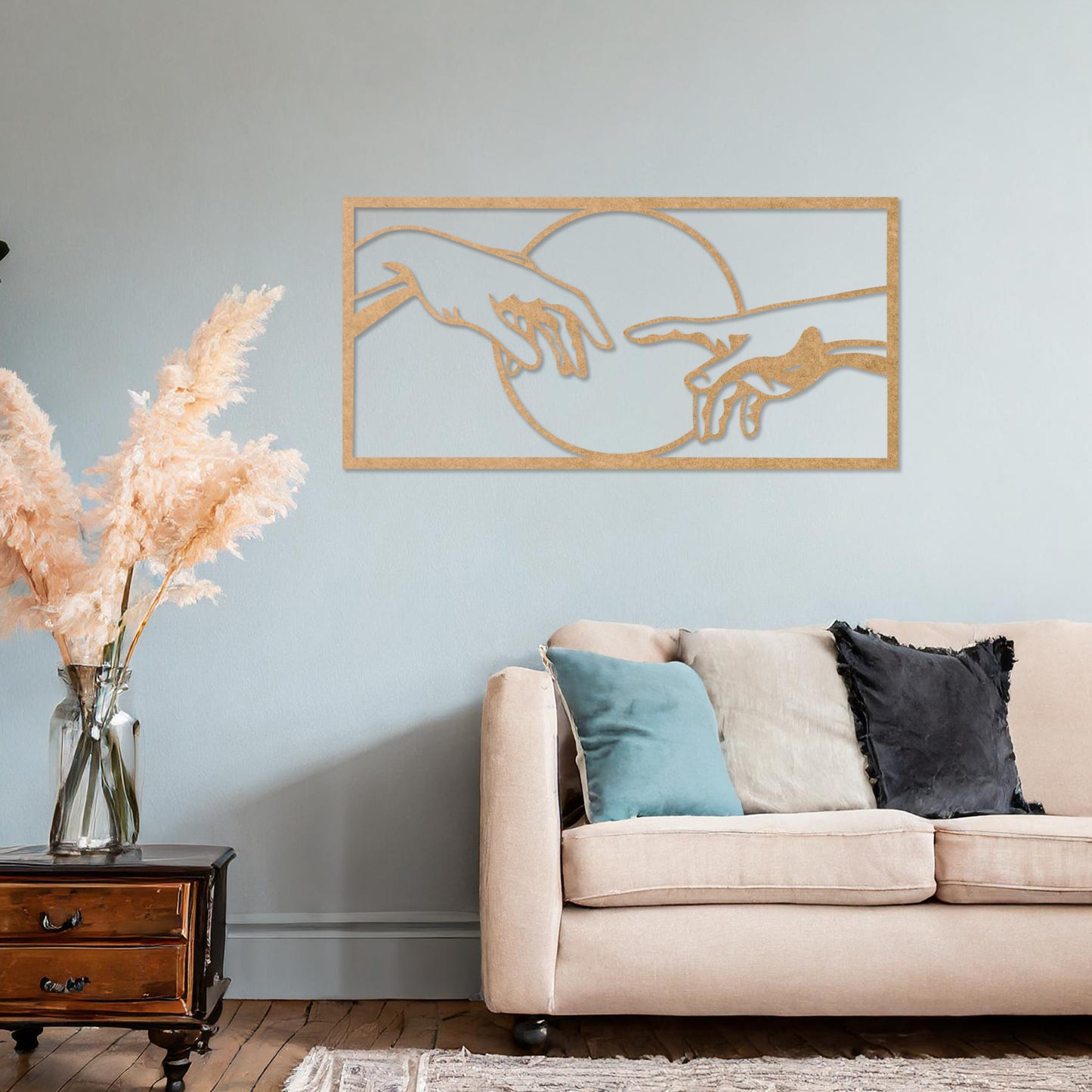 Wooden wall art featuring a minimalist depiction of two hands reaching out towards each other, framed by a circular design. Mounted on a neutral wall within modern room decor, this piece adds an artistic and meaningful touch to any space.
