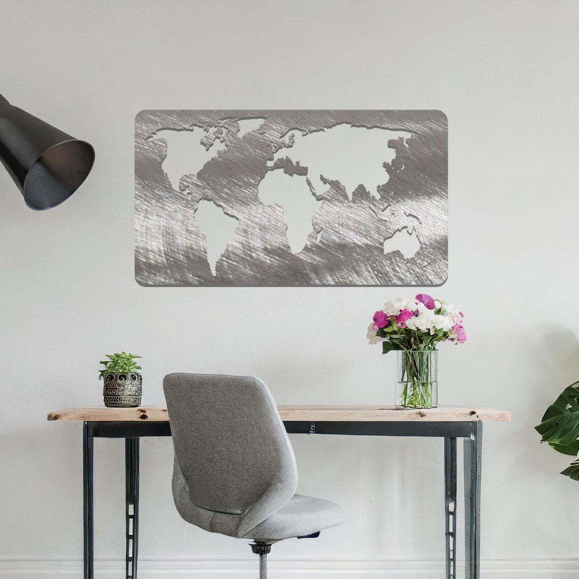 Metal wall art featuring a rectangular world map design with precise continent outlines, serving as a stylish and sophisticated addition to the space.