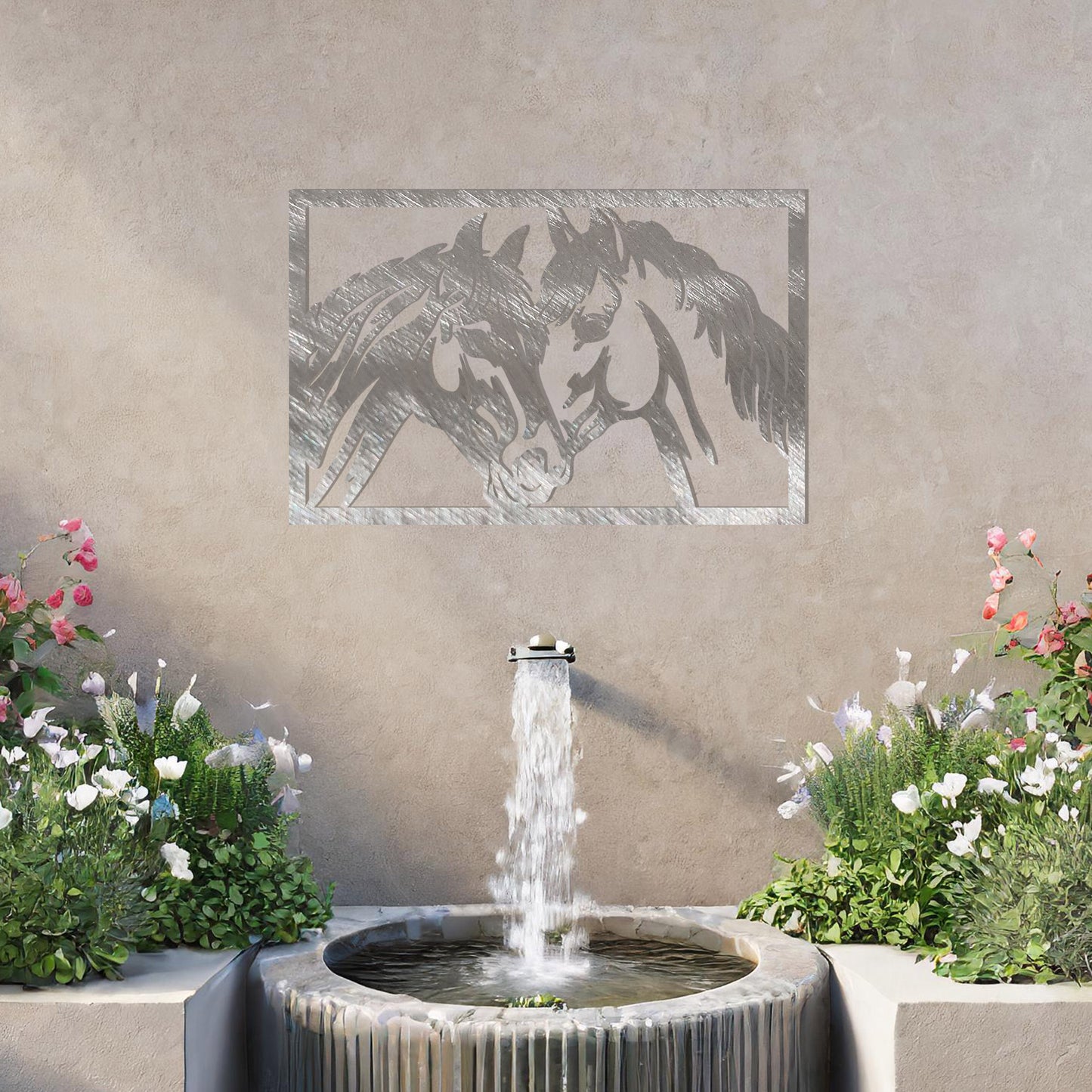 A captivating metal wall art design showcasing two horses facing each other within a rectangular frame, symbolising connection and affection. This piece beautifully complements a neutral wall in a serene and elegantly decorated outdoor space.