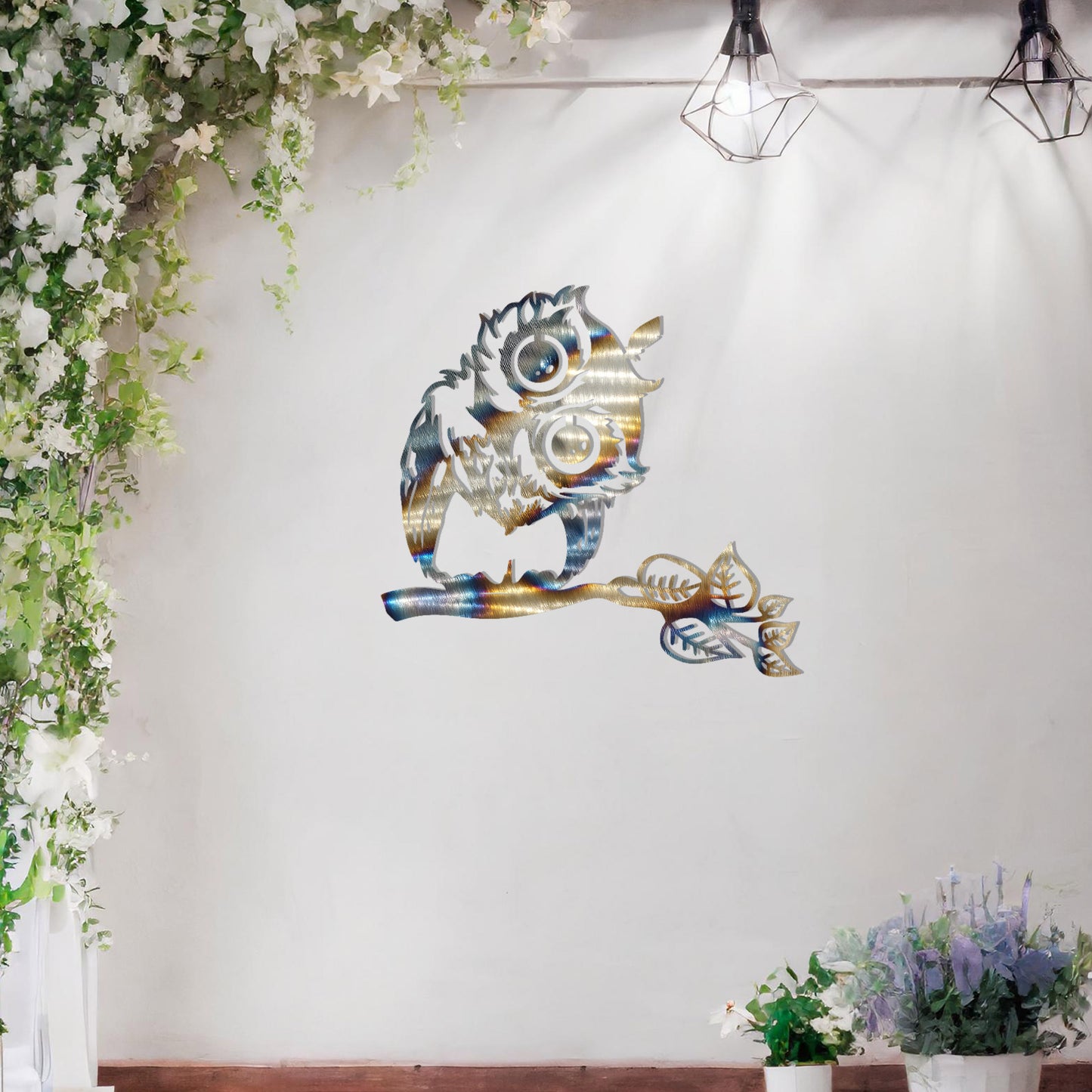 A delightful metal wall art design featuring a whimsical owl perched on a branch with intricate detailing of its feathers and expressive eyes, adding a playful and nature-inspired touch to any setting.
