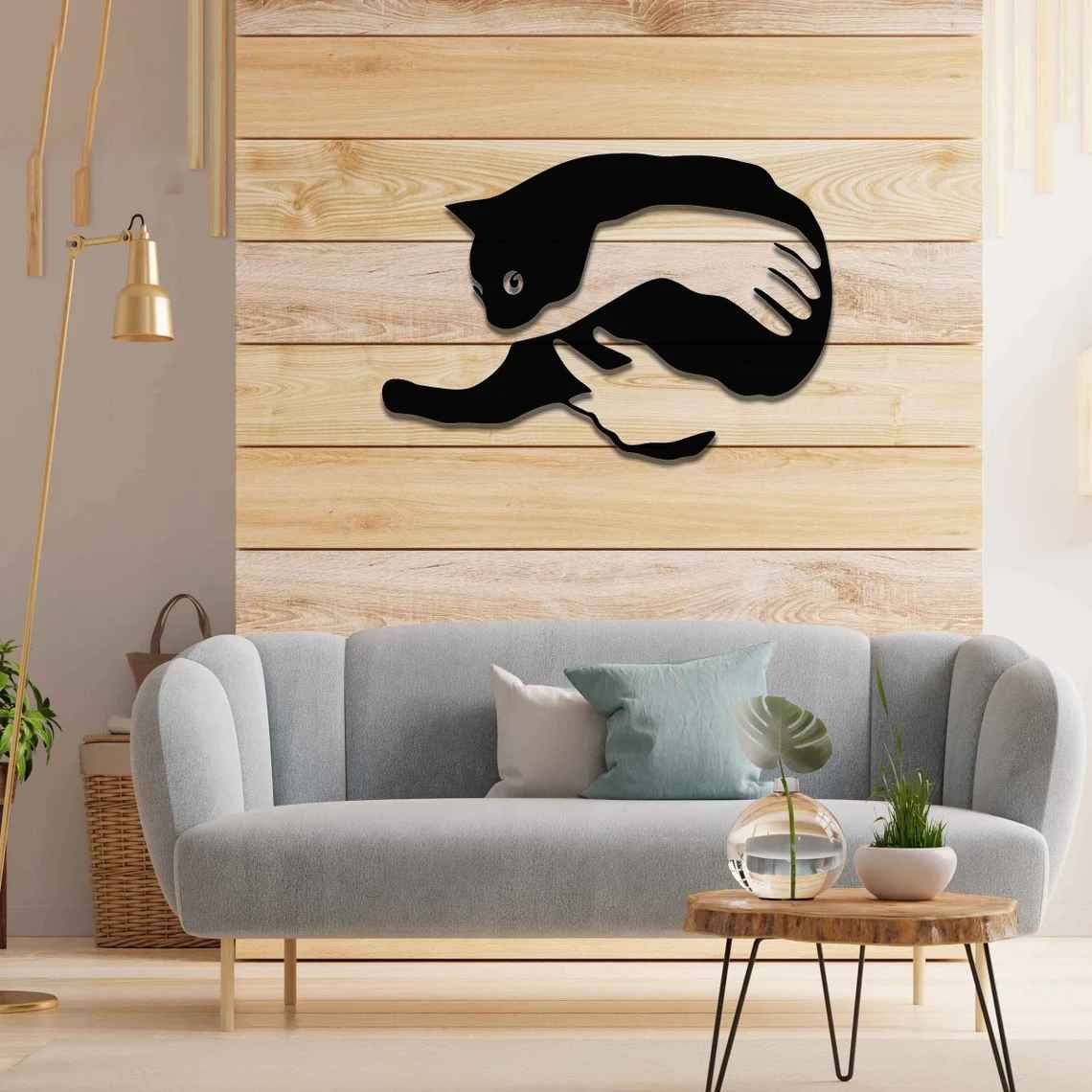 Metal wall art featuring a minimalist silhouette of a cat being gently held by a pair of hands. A striking and heartwarming design that adds an artistic and cosy touch to any modern or contemporary space.