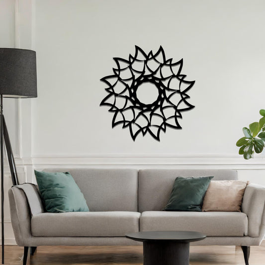 Metal wall art featuring a circular floral-inspired design with layered petal-like patterns, crafted with precise laser-cut detailing, displayed on a neutral wall within modern decor.