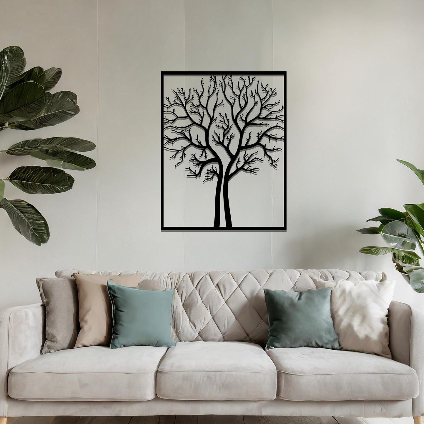 Metal wall art featuring a framed tree design with intricate, bare branches, crafted with precise laser-cut techniques, displayed on a neutral wall within modern decor.