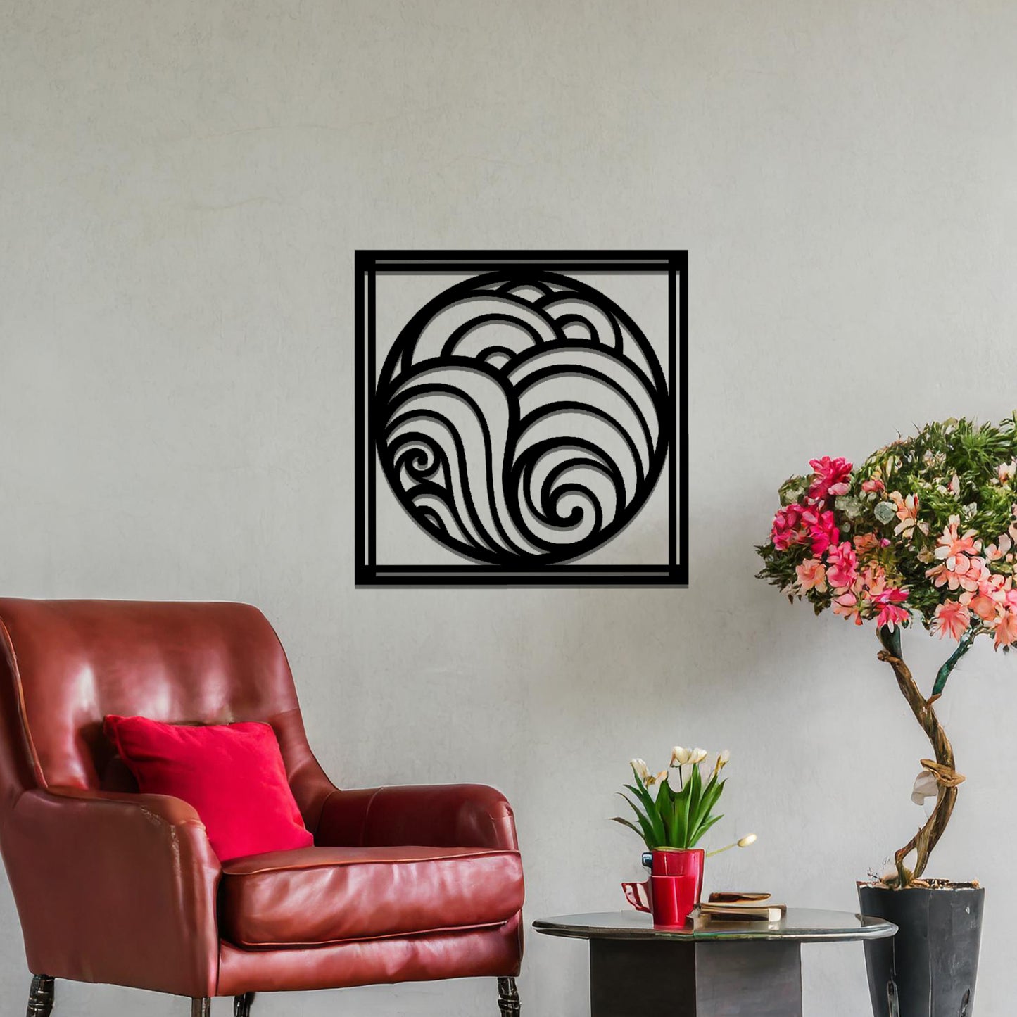 Metal wall art featuring a square design with swirling wave patterns inside a circular frame, mounted on a neutral wall within modern decor. The flowing lines and fluid shapes create a peaceful and dynamic focal point, enhancing the space.