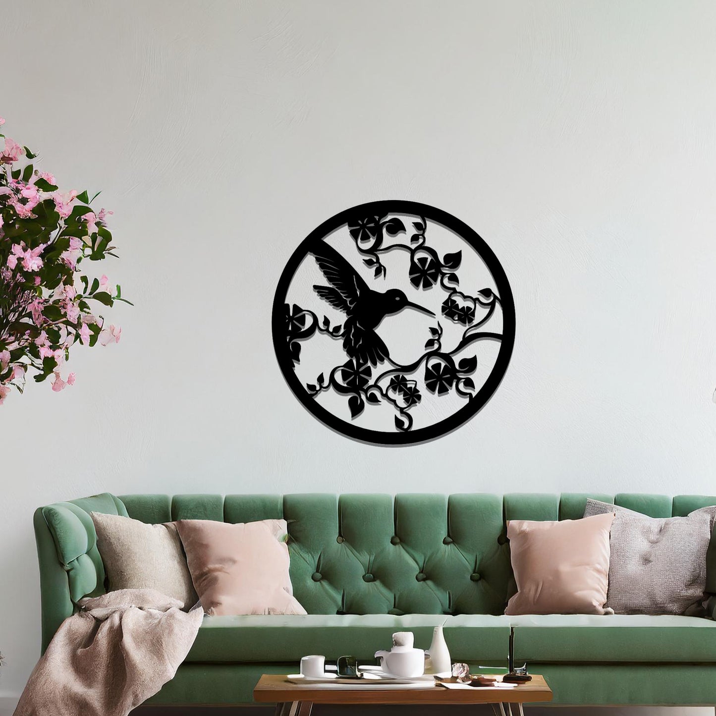 Metal wall art featuring a bird perched on floral vines in a circular design. The intricate patterns of the leaves and branches are beautifully balanced, creating a harmonious look. The art is placed on a neutral wall within modern room decor.