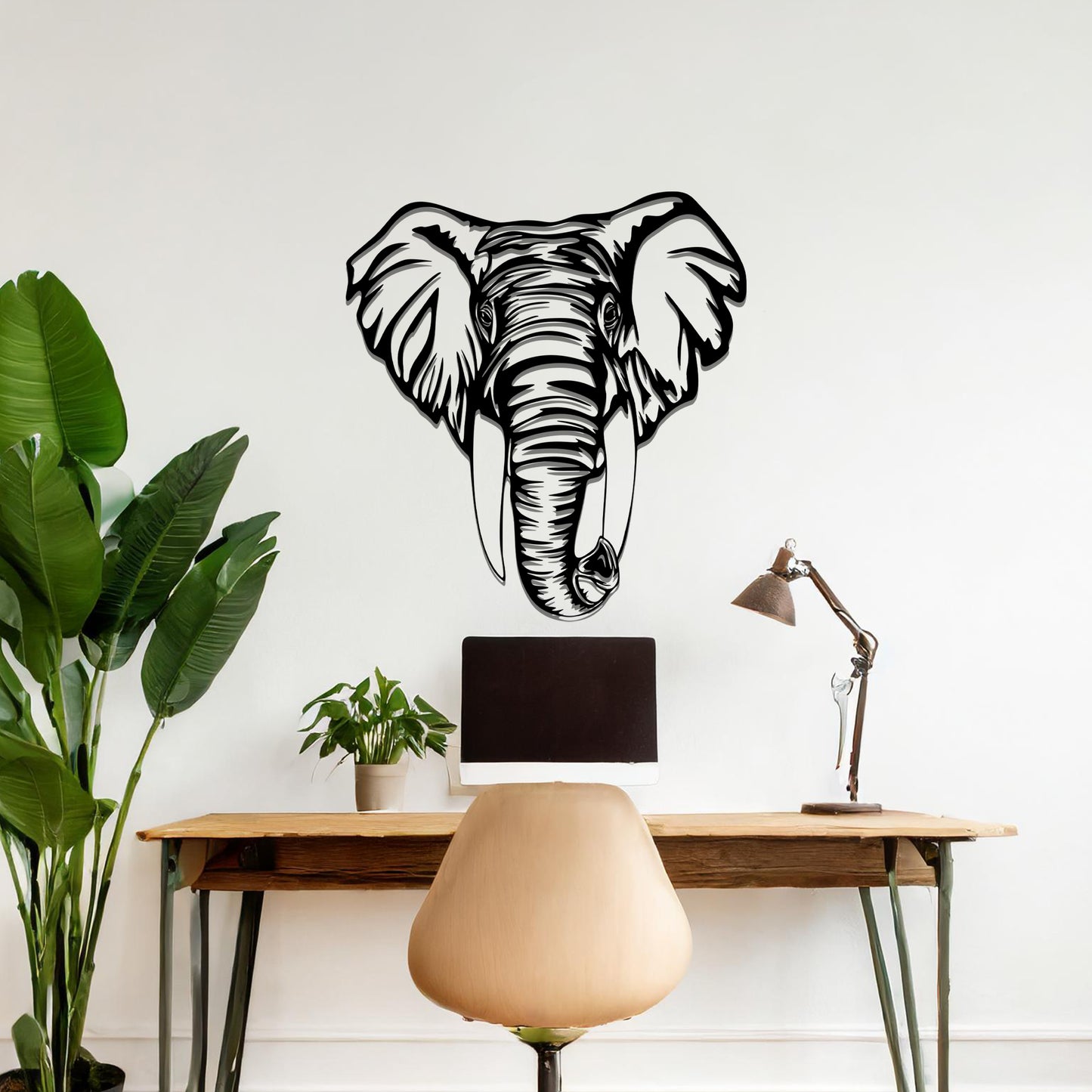 Metal wall art featuring a detailed elephant head design with intricate lines and realistic features, crafted with precise laser-cut techniques, displayed on a neutral wall within modern decor.