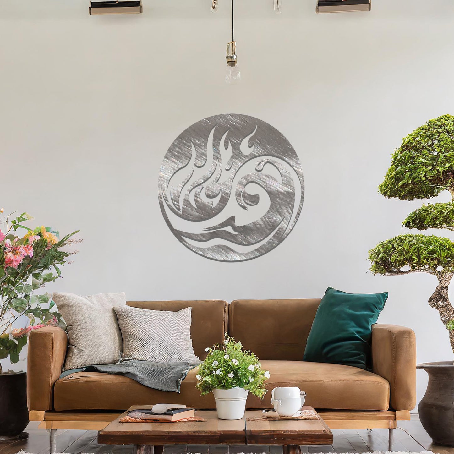 Metal wall art featuring a circular design with a dynamic swirl of flames and waves, mounted on a neutral wall within modern decor. The fluid lines and bold elements create a striking and energetic focal point for the room.