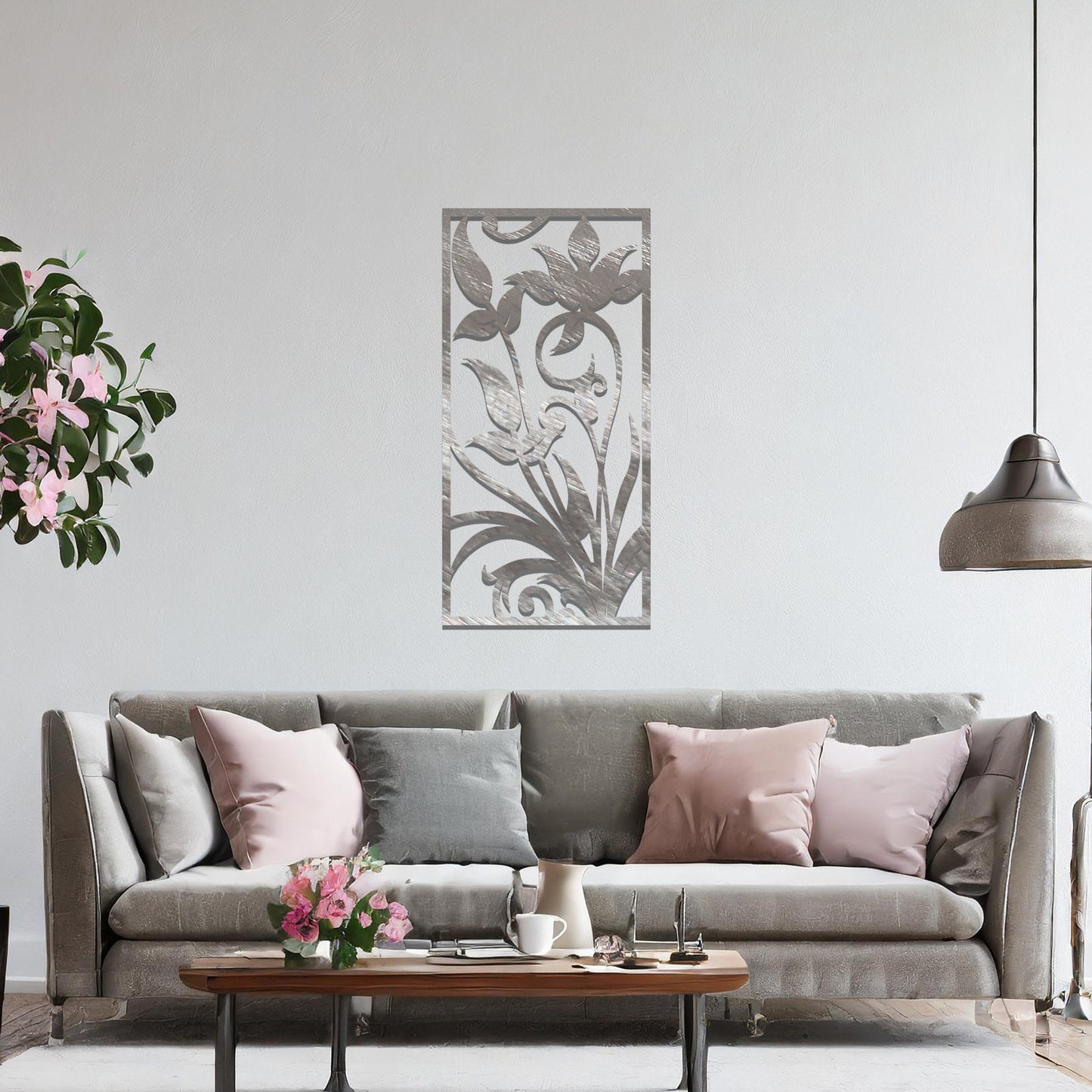 Metal wall art featuring a vertical design with elegant floral motifs and intricate swirling patterns, mounted on a neutral wall within sophisticated room decor. The delicate floral silhouette adds a refined and artistic touch to the space.