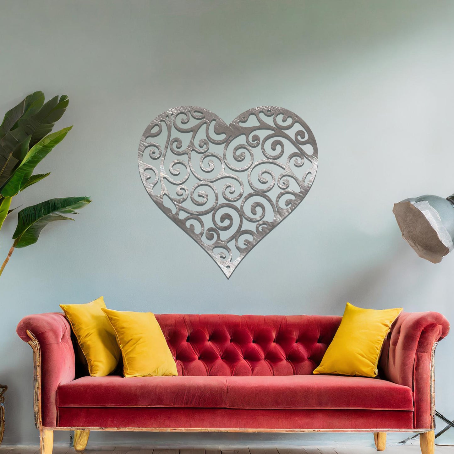 Metal wall art featuring a heart-shaped design with intricate swirling patterns, adding an elegant and romantic touch to the room’s decor.
