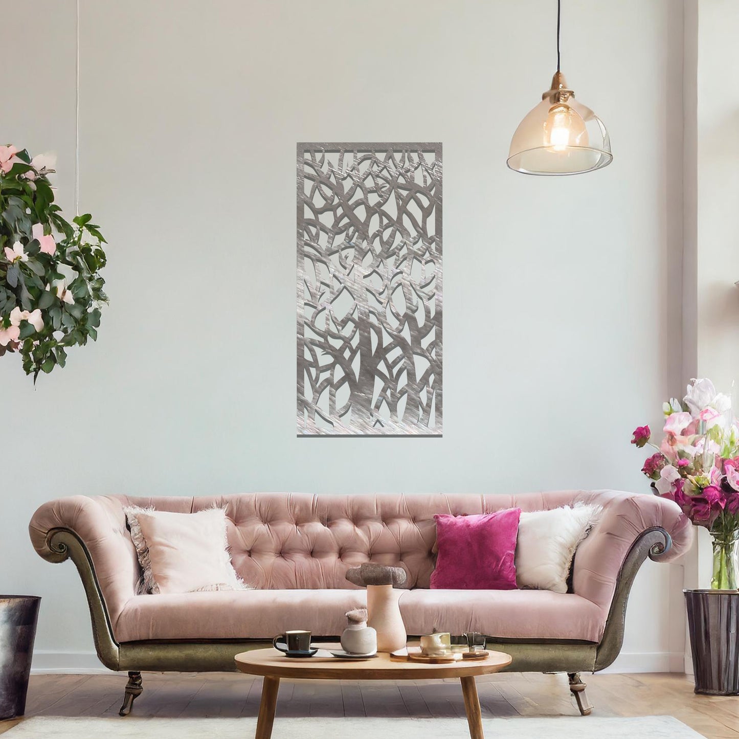 Metal wall art featuring a rectangular design with intricate tree branches and abstract shapes, creating a visually captivating and artistic focal point for the room.