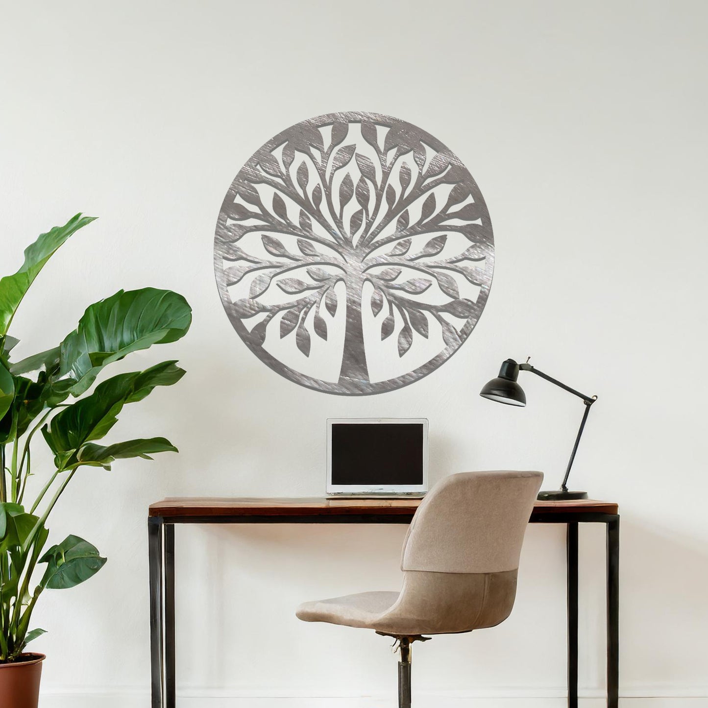 Metal wall art featuring a circular tree design with symmetrical branches and leaves, creating a balanced and nature-inspired focal point for the room.