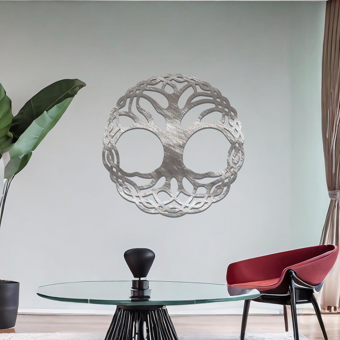 Metal wall art featuring a circular tree of life design with intricately interwoven branches and roots, creating a harmonious and symbolic focal point for the room.