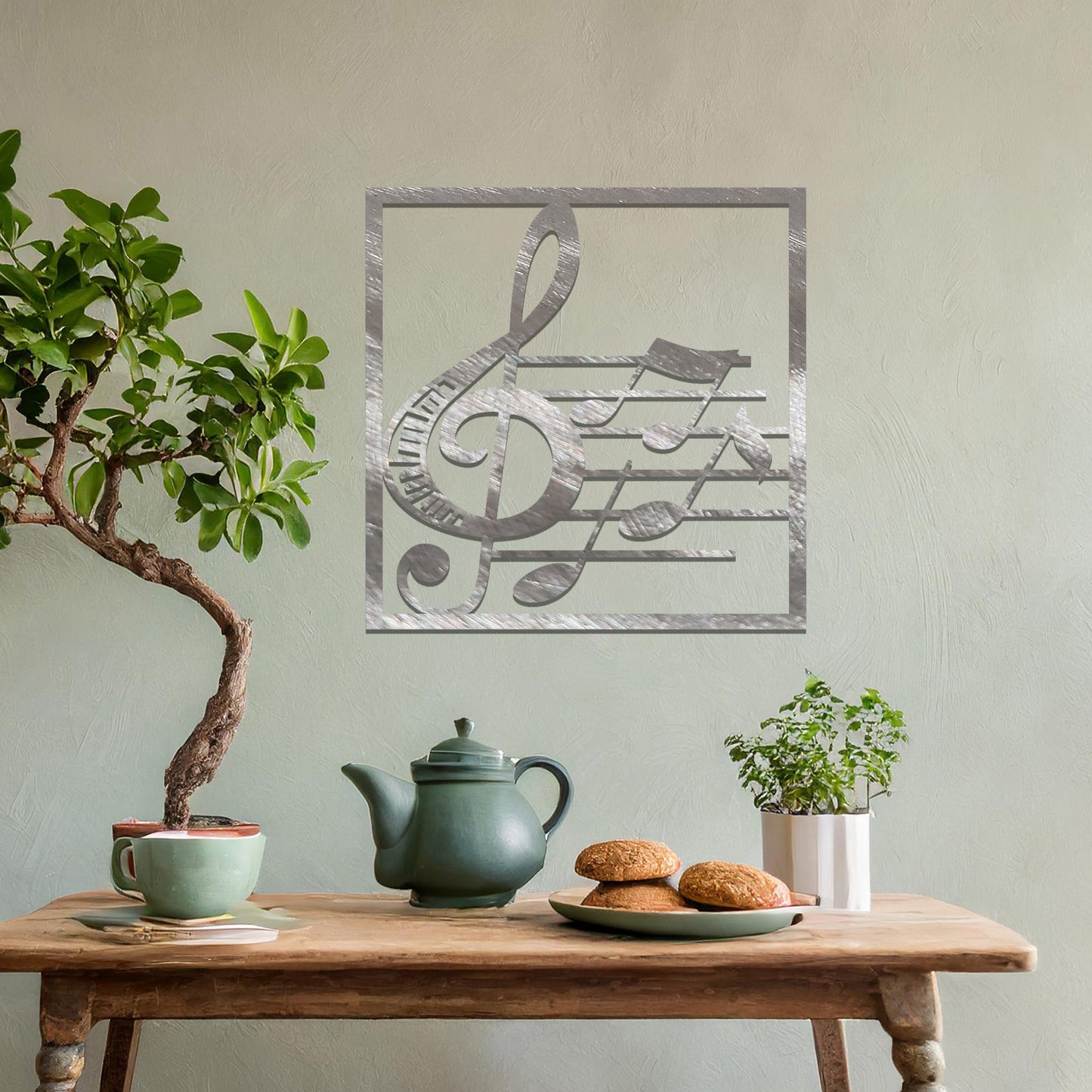 Metal wall art featuring a square design with a treble clef and musical notes on a staff, adding a harmonious and artistic touch to the space.
