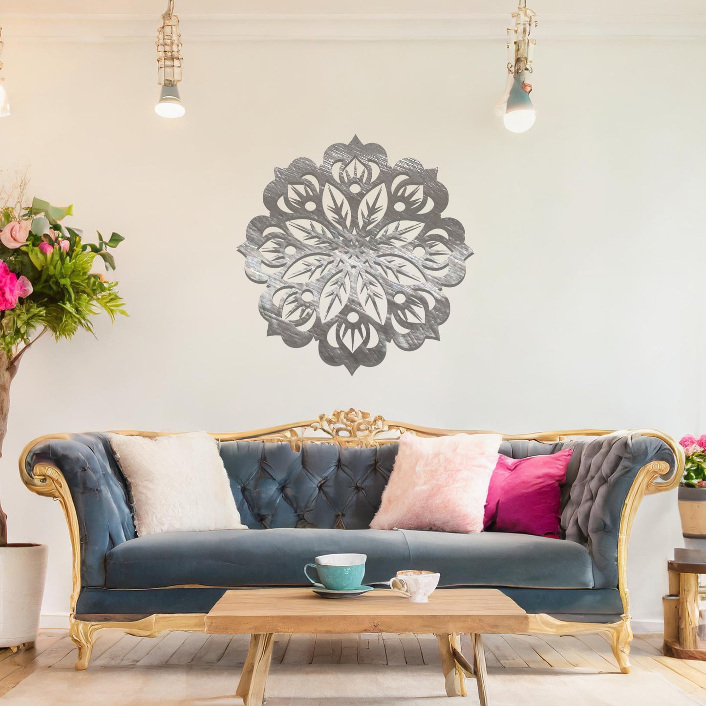 Metal wall art featuring an intricate mandala design with symmetrical floral patterns, mounted on a neutral wall within modern room decor. The detailed craftsmanship and balanced geometry create a striking focal point, enhancing the sophistication of the space.