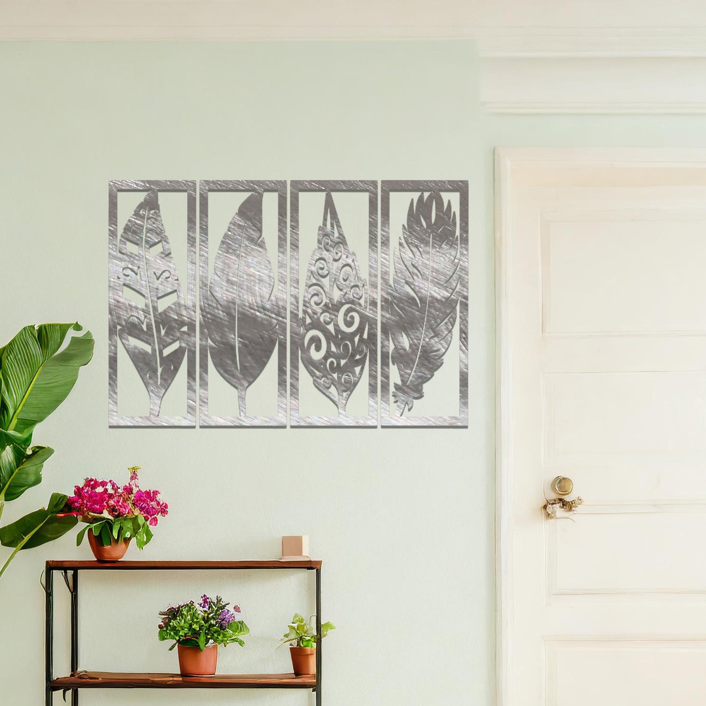 Metal wall art featuring five rectangular panels with detailed leaf designs, each panel showcasing a unique pattern. The art is mounted on a neutral wall within a modern office setting, adding a natural touch to the workspace decor.