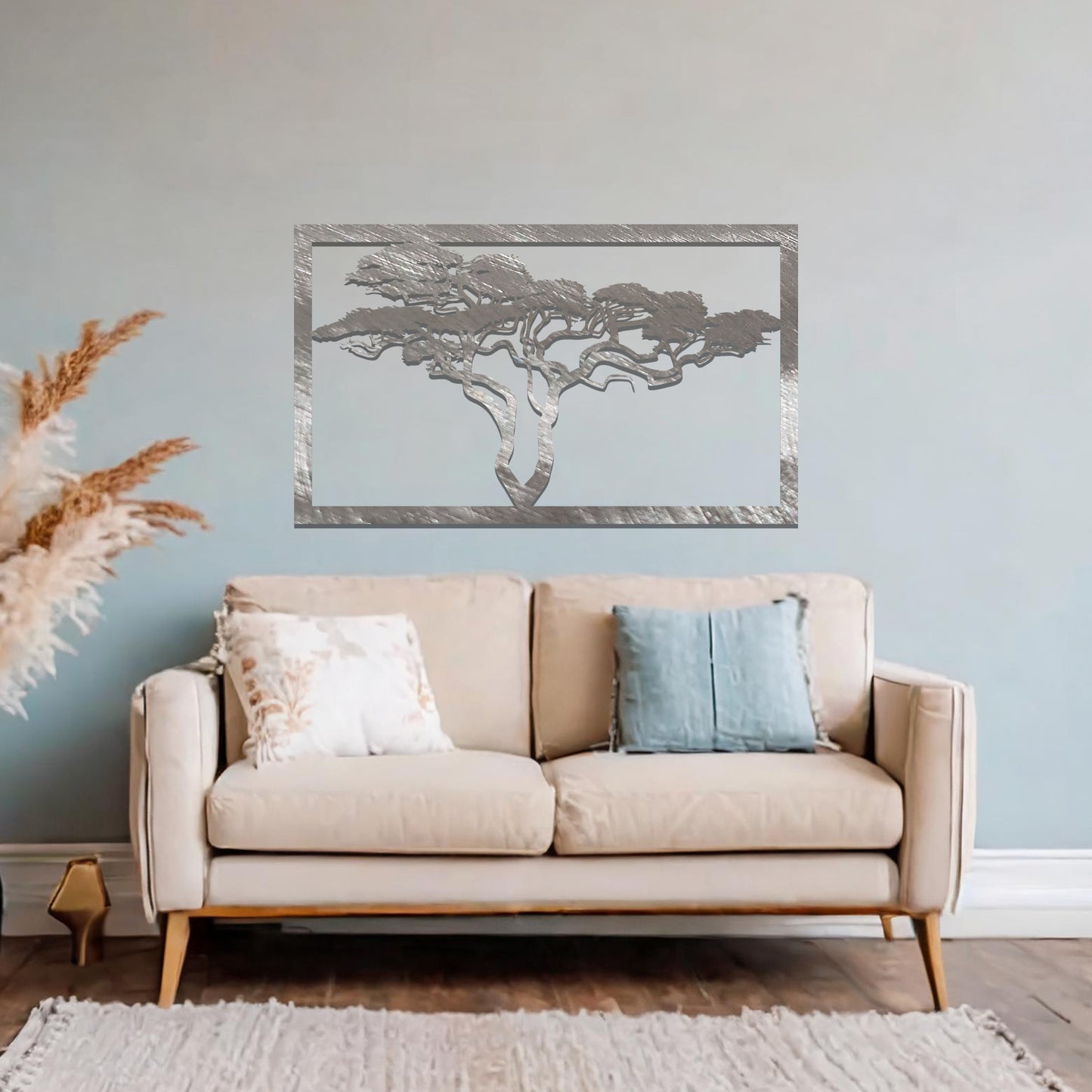 Metal wall art featuring a rectangular design with a silhouette of an African tree, showcasing intricate branch details, mounted on a neutral wall within modern office decor. The elegant craftsmanship adds a natural and sophisticated touch to the contemporary workspace.