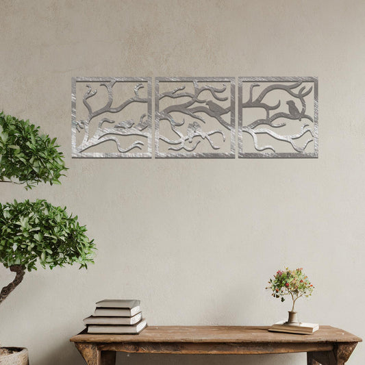 Three-panel metal wall art featuring an elegant design of birds perched on branches, creating a peaceful and nature-inspired aesthetic.