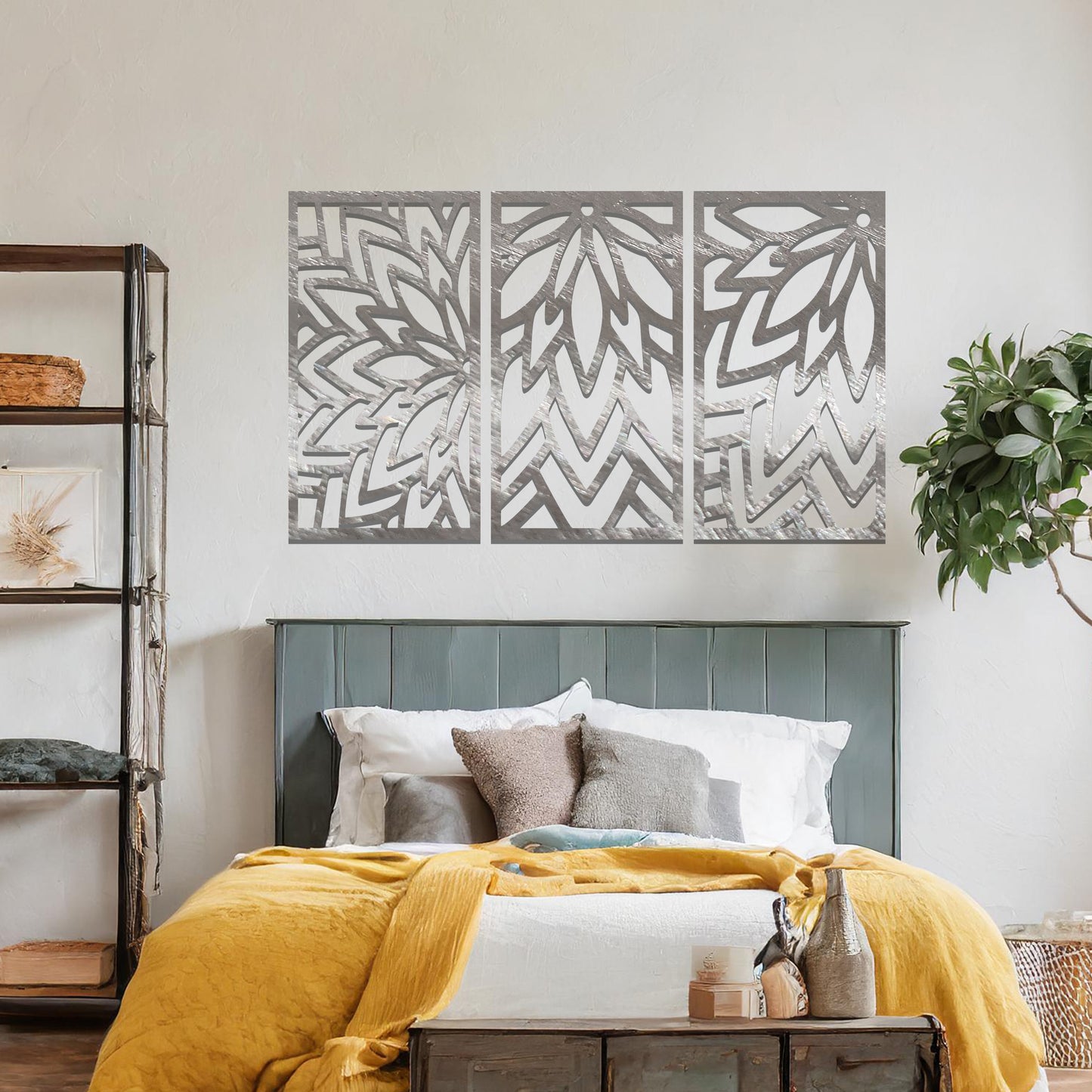 Metal wall art featuring a three-panel design with floral-inspired geometric patterns, crafted with precise laser-cut detailing, displayed on a neutral wall within modern decor.