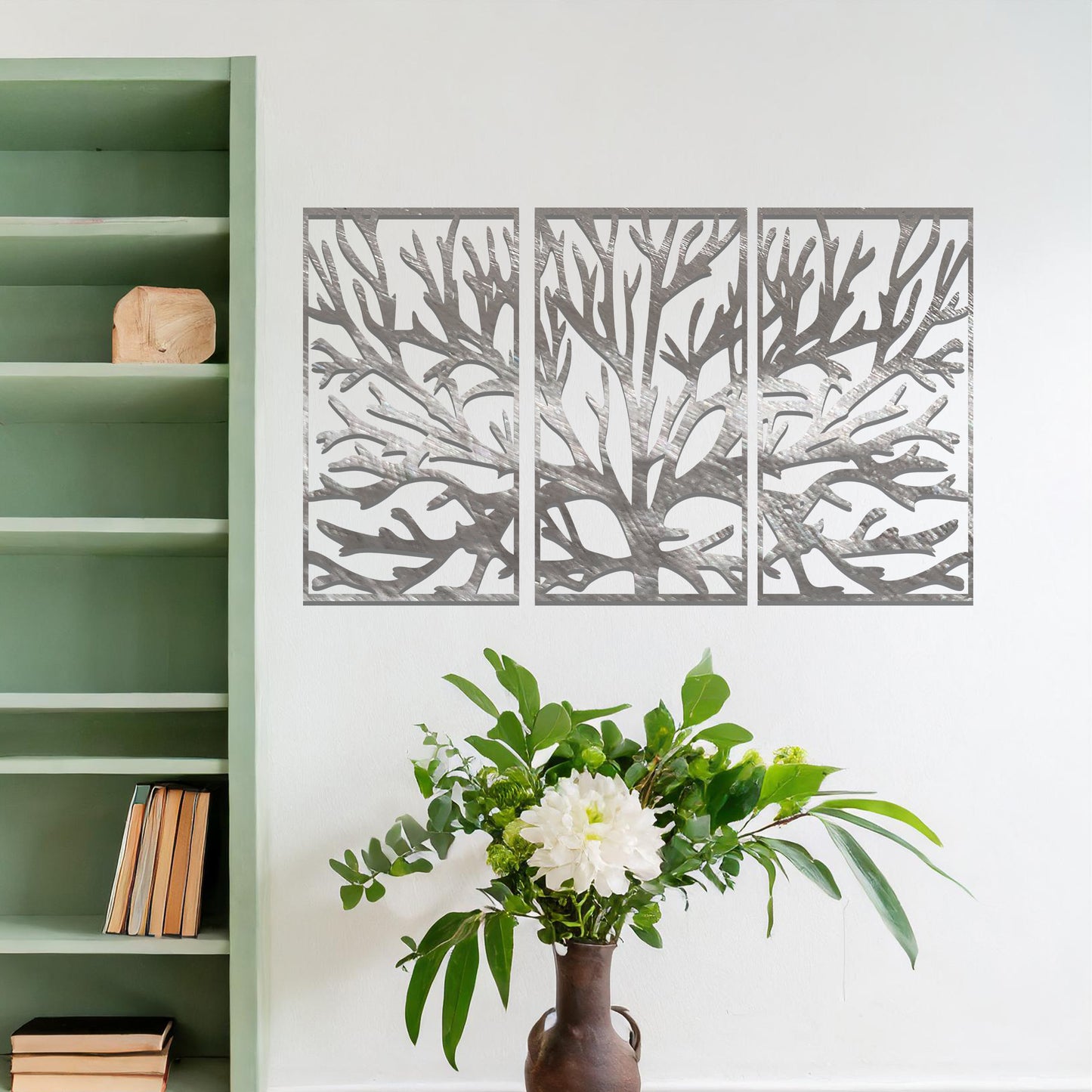 Metal wall art design featuring a stylized tree with intricate branches, presented in a triptych layout. The design captures detailed, organic lines forming the tree’s structure, emphasizing the natural flow and texture of the branches. The art is displayed on a neutral wall.