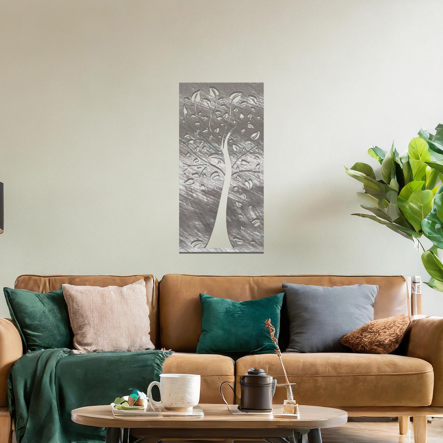 Metal wall art featuring a tree with intricate branches and leaves, enclosed in a vertical rectangular frame. The artwork is displayed on a neutral wall within a modern office setting, complemented by a desk, chair, and indoor plants.