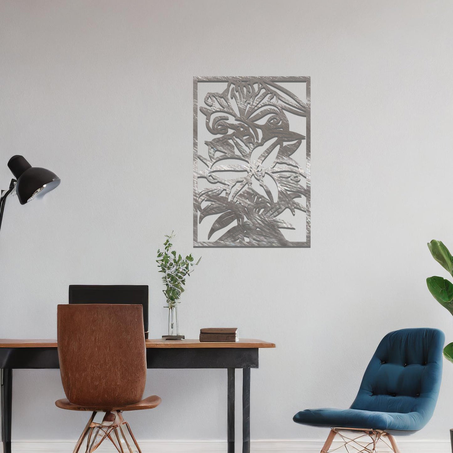 A metal wall art design showcasing a floral pattern with a large flower and leaves, set within a rectangular frame. The art is displayed on a neutral wall in a modern living room, adding an elegant and natural touch to the space.