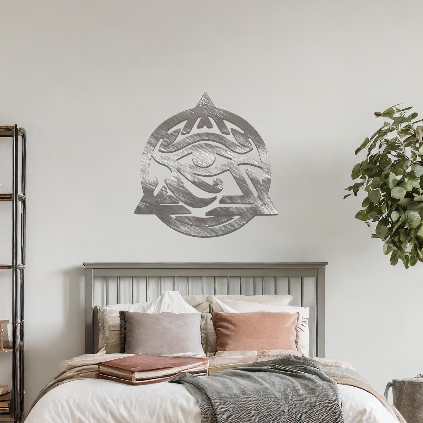 Metal wall art featuring an intricate design of the Eye of Horus, enclosed within a geometric triangle and circle. The artwork is placed on a neutral wall in a modern living room setting, adding to the contemporary decor.