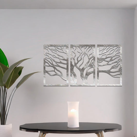 Three-panel metal wall art featuring intricately cut tree branches in a flowing design, creating a dynamic and organic effect.