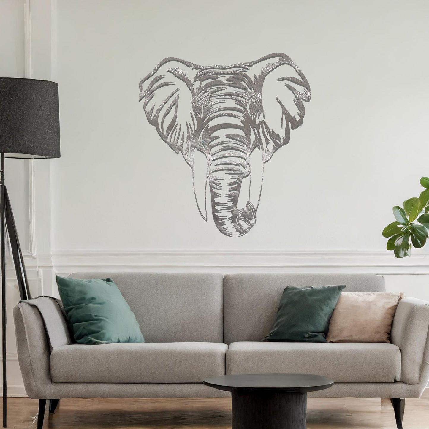 Metal wall art featuring a detailed elephant head design with intricate lines and realistic features, crafted with precise laser-cut techniques, displayed on a neutral wall within modern decor.