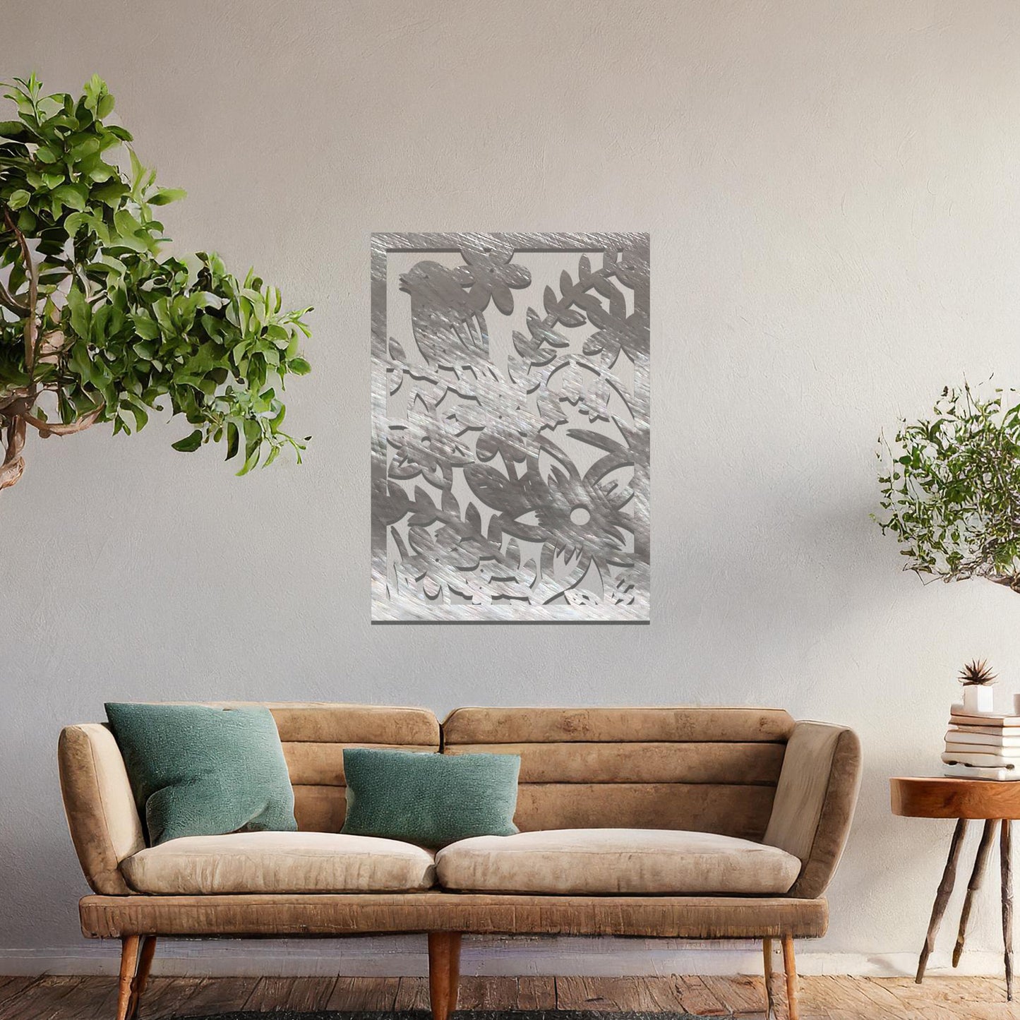 Metal wall art featuring a rectangular design with a bird perched amidst detailed floral and leafy patterns, mounted on a neutral wall within modern room decor. The intricate details and natural elements create a lively and elegant focal point.