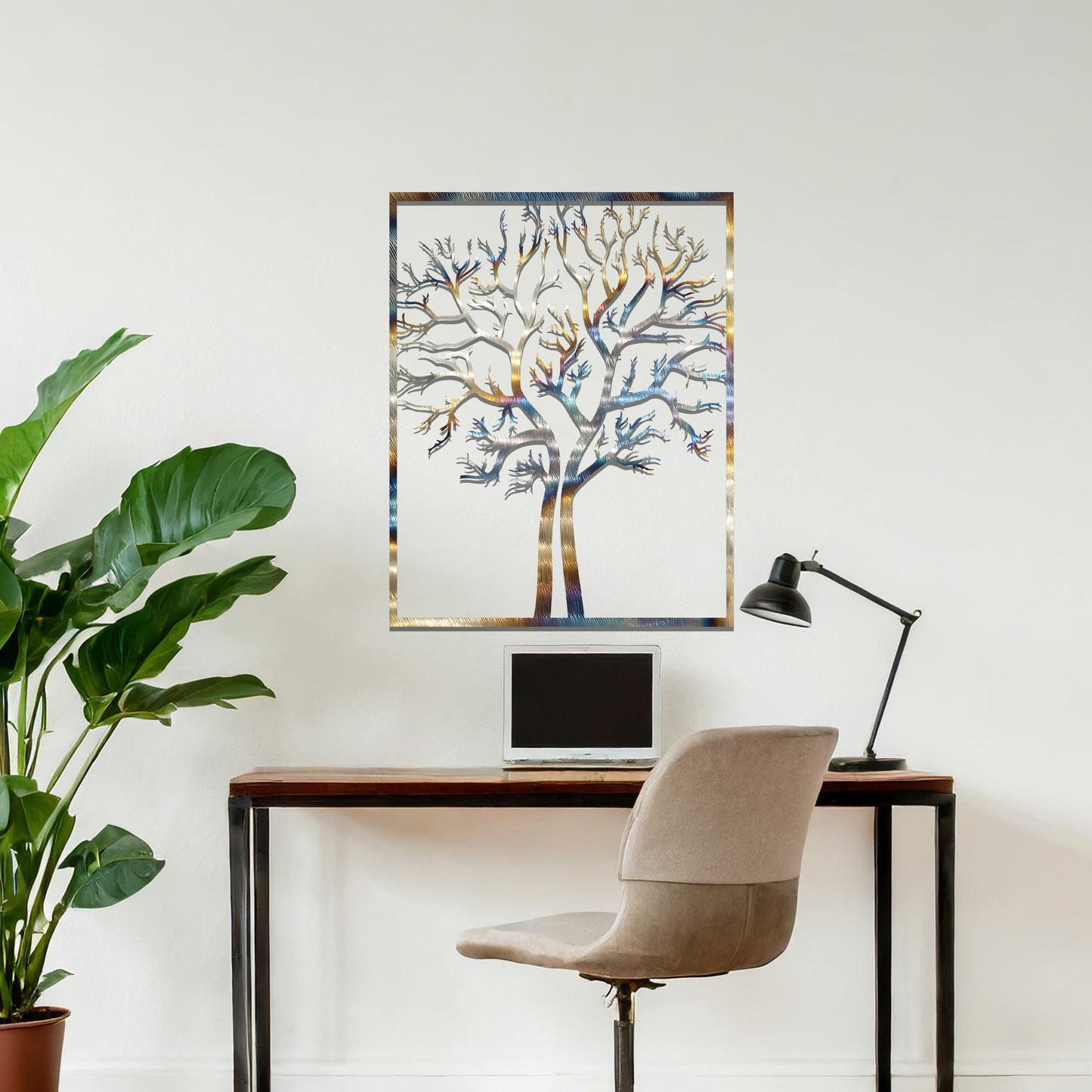 Metal wall art featuring a framed tree design with intricate, bare branches, crafted with precise laser-cut techniques, displayed on a neutral wall within modern decor.