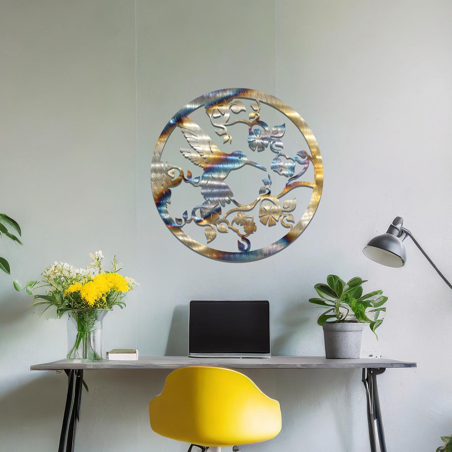 Metal wall art featuring a bird perched on floral vines in a circular design. The intricate patterns of the leaves and branches are beautifully balanced, creating a harmonious look. The art is placed on a neutral wall within modern room decor.