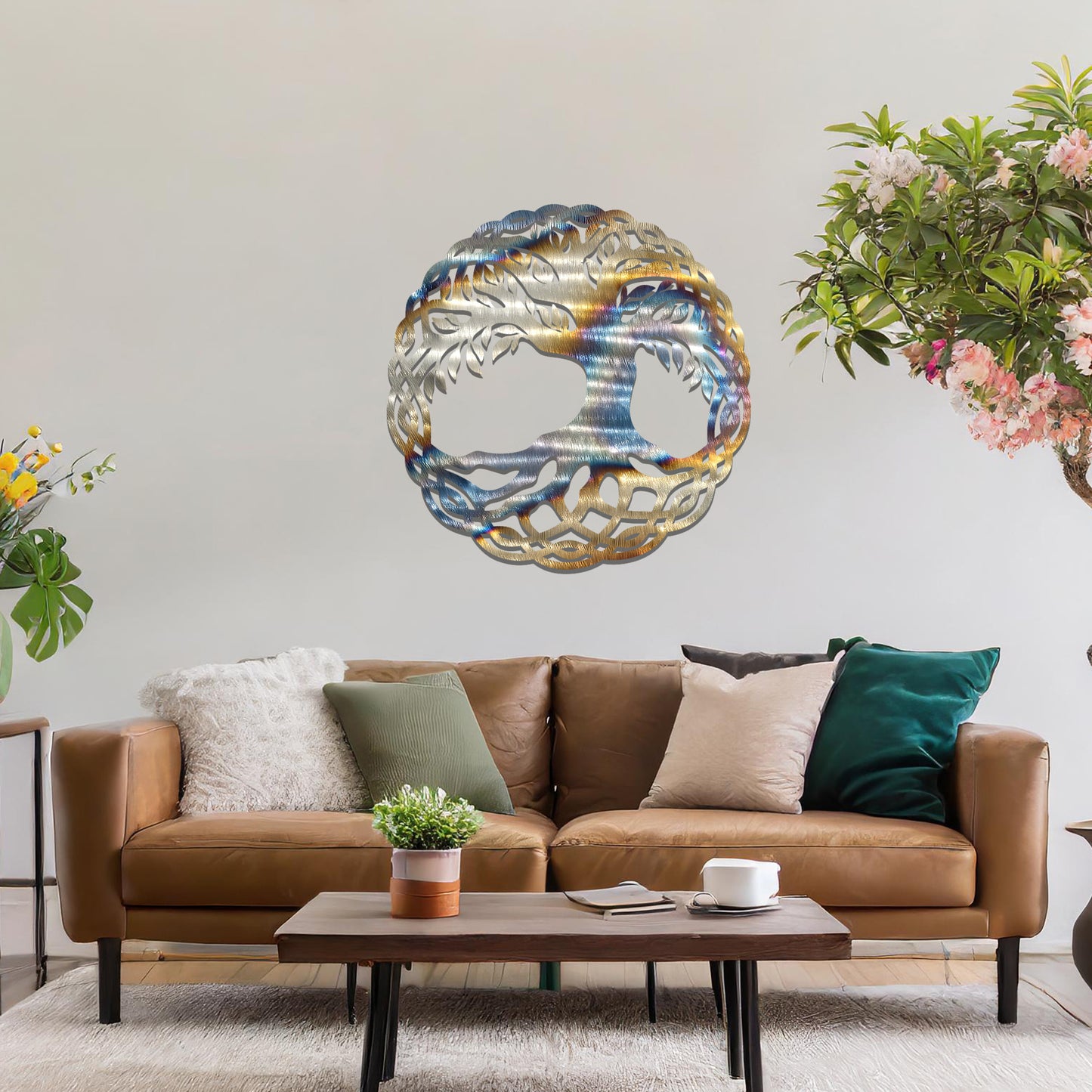 Metal wall art featuring a circular tree of life design with intricate roots and branches enclosed in a detailed border, crafted with precise laser-cut techniques, displayed on a neutral wall within modern decor.