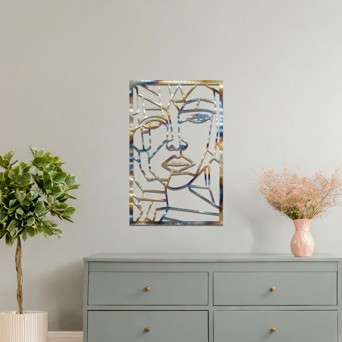 Abstract geometric face design with angular lines and sharp contours, creating a unique and modern look. The art is displayed on a neutral wall in a stylish room with contemporary furniture and vibrant flowers.