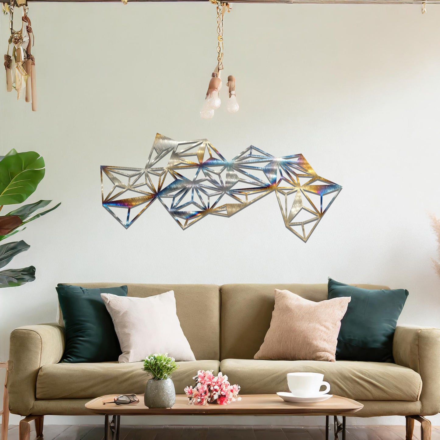 Metal wall art featuring an abstract geometric design with multiple interconnected triangular shapes, creating a dynamic, faceted pattern. The art is placed on a neutral wall within a modern room, complementing the vibrant decor with plants and furniture.