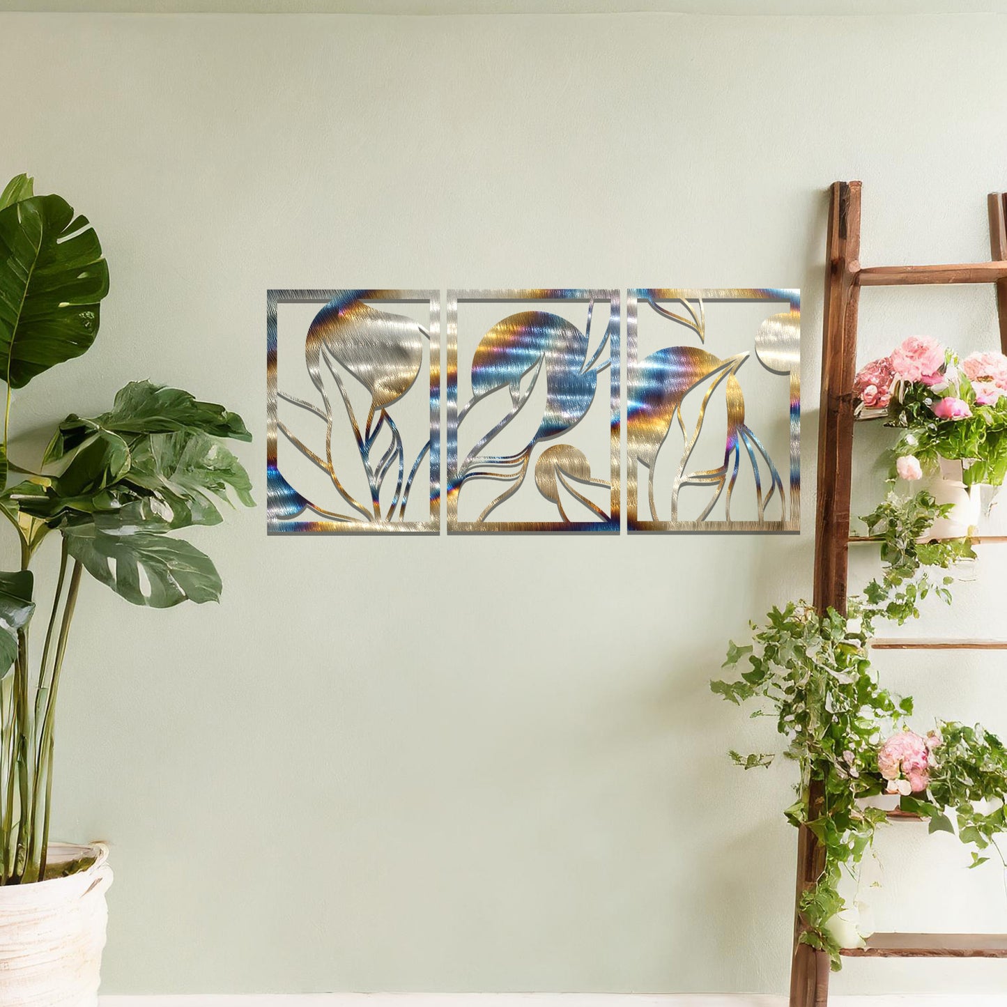 Metal wall art featuring a three-panel design with abstract floral and circular elements, mounted on a neutral wall within modern decor. The rust finish and fluid shapes create a warm and artistic focal point in the room.