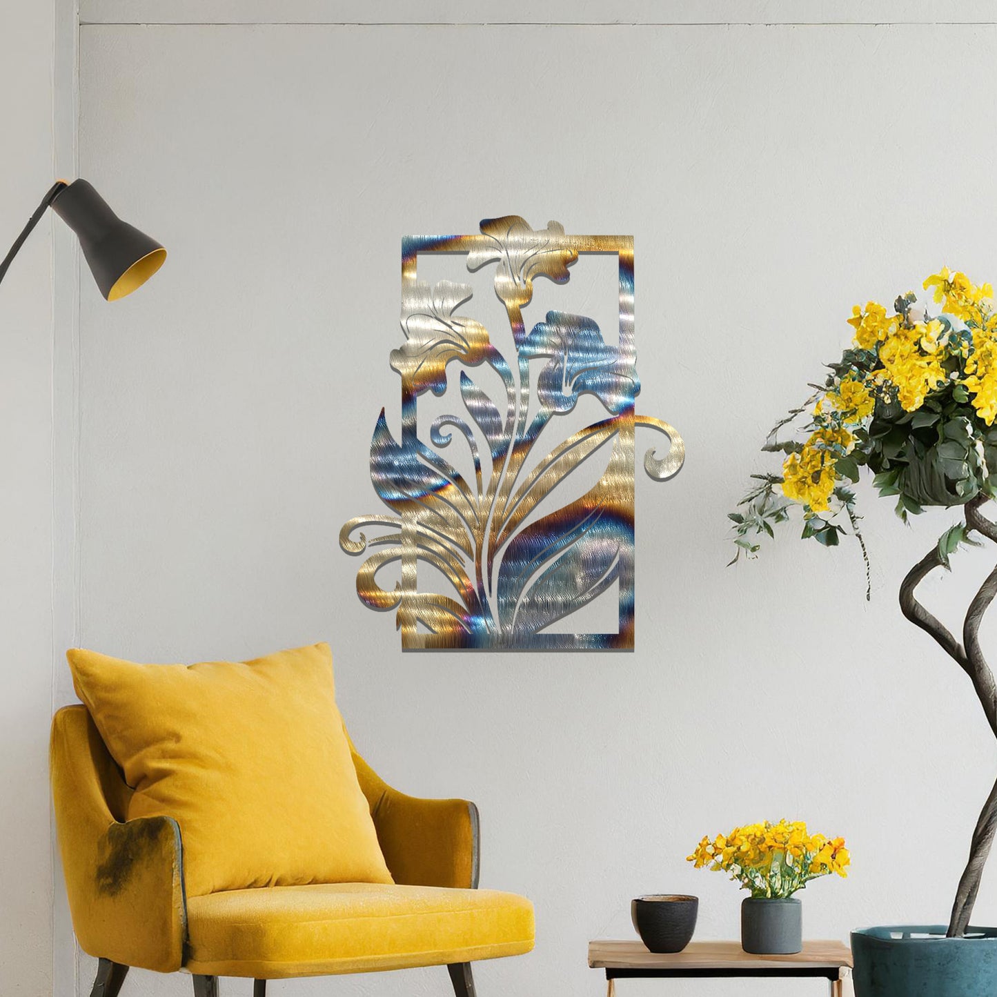 A metal wall art design featuring a graceful floral arrangement with flowers and curving leaves within a rectangular frame. The art is displayed on a neutral wall in a modern living room, enhancing the space with a touch of elegance and nature.