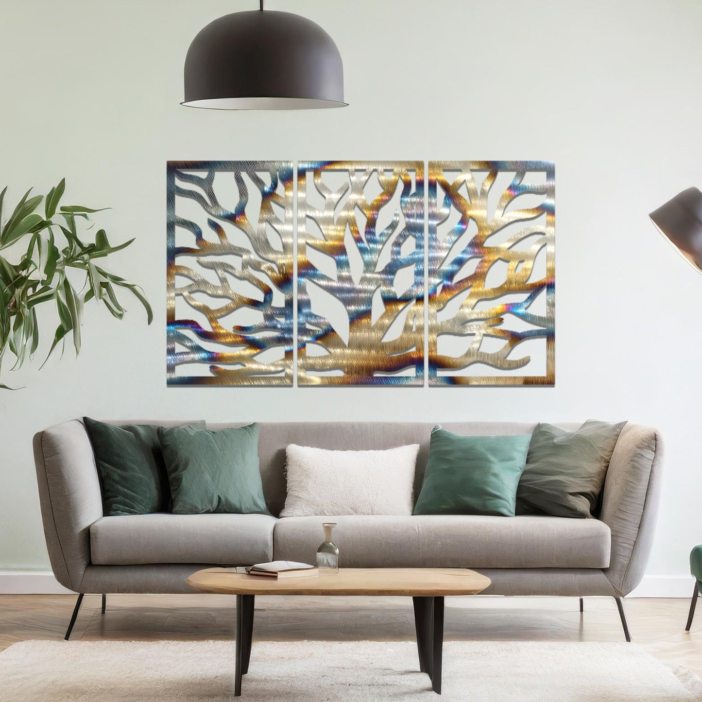 Metal wall art featuring a three-panel design of a tree with intricate branching patterns, crafted with precise laser-cut detailing, placed on a neutral wall within modern decor.