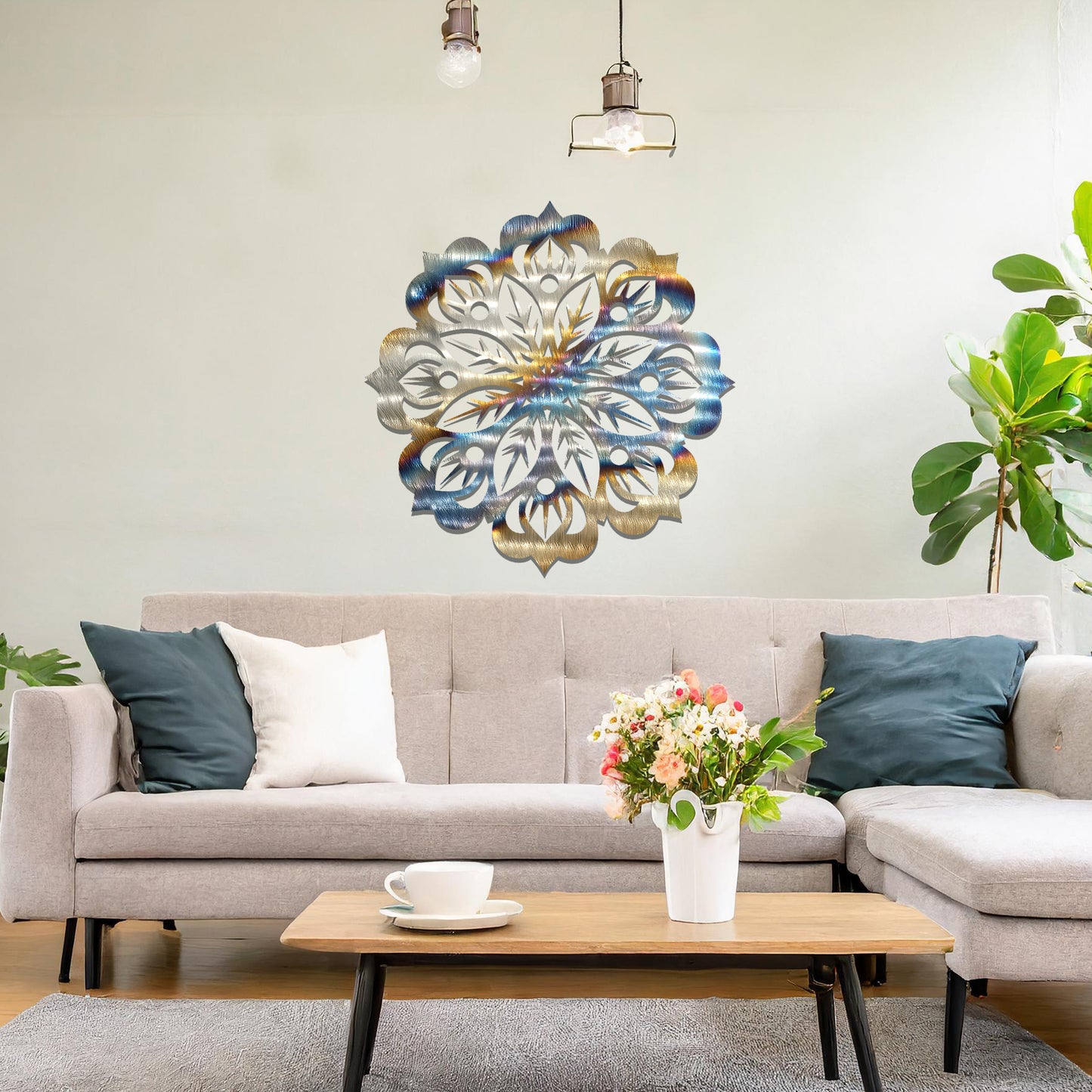 Metal wall art featuring an intricate mandala design with symmetrical floral patterns, mounted on a neutral wall within modern room decor. The detailed craftsmanship and balanced geometry create a striking focal point, enhancing the sophistication of the space.