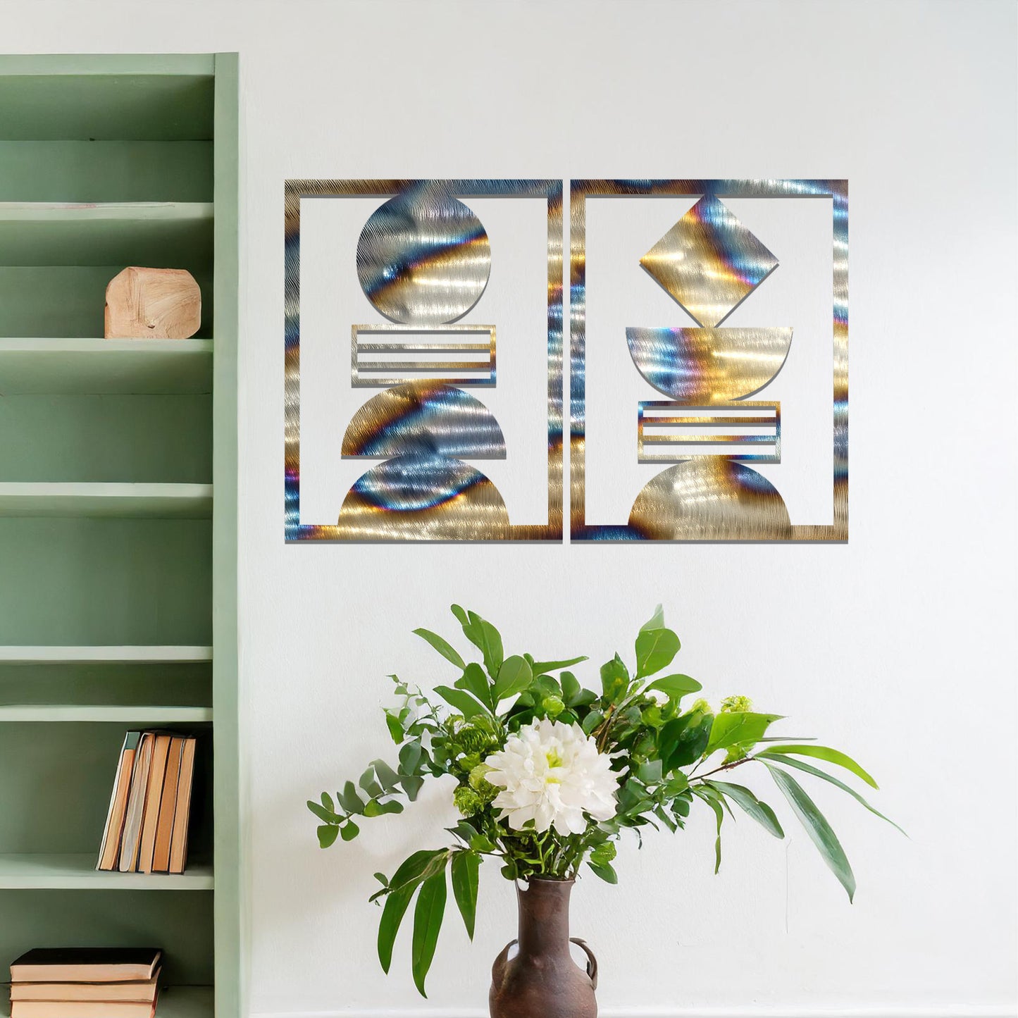 A metal wall art set featuring geometric shapes, including circles and a diamond, arranged in a balanced and symmetrical design. The art is displayed on a neutral wall within modern room decor, adding an elegant and abstract touch to the space.