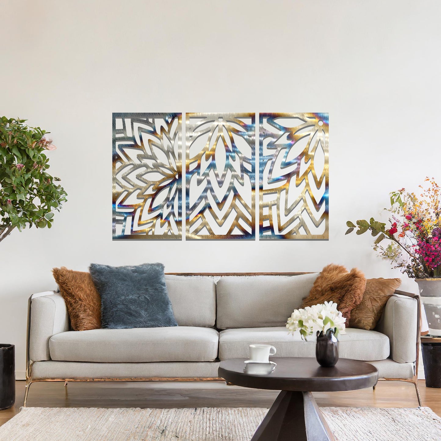 Metal wall art featuring a three-panel design with floral-inspired geometric patterns, crafted with precise laser-cut detailing, displayed on a neutral wall within modern decor.
