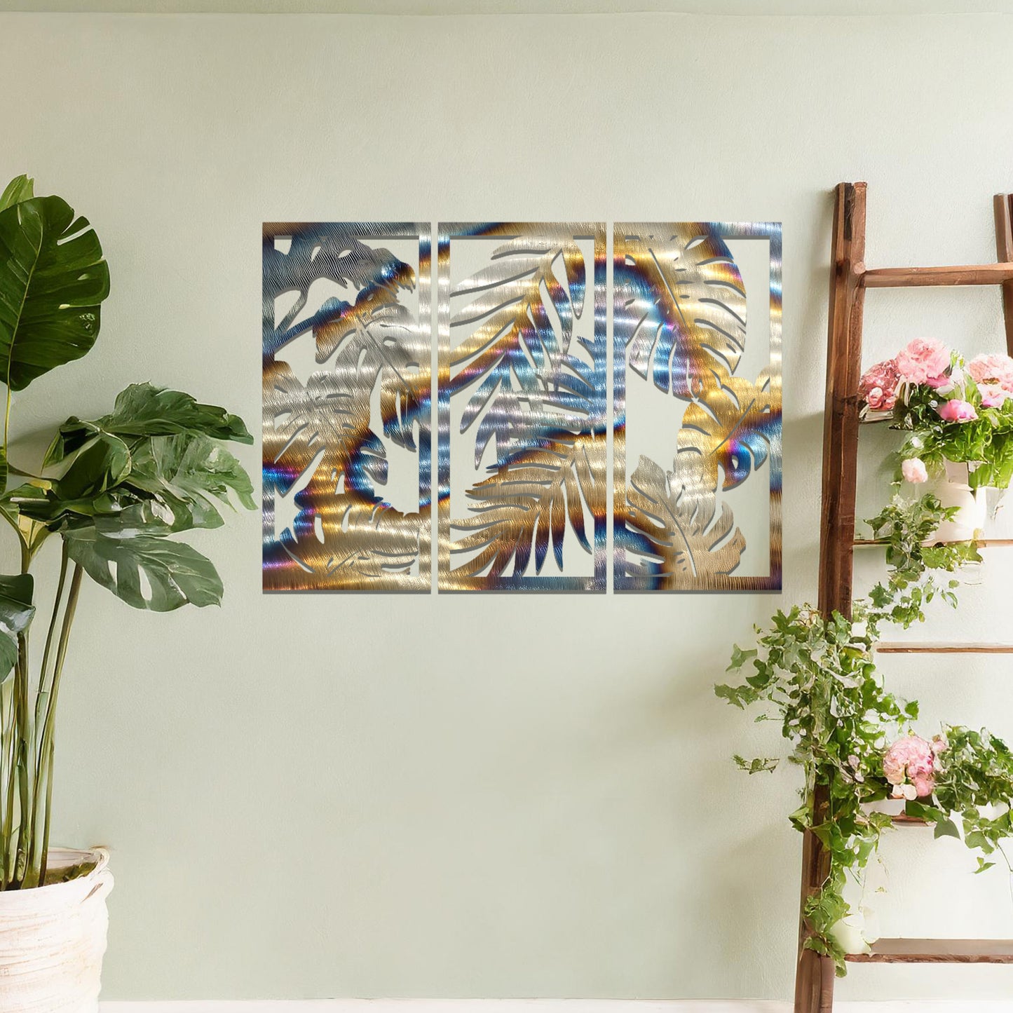 A tropical wall art set featuring a trio of panels adorned with intricate monstera and palm leaf patterns. Perfect for bringing a lush, botanical vibe to your indoor spaces.