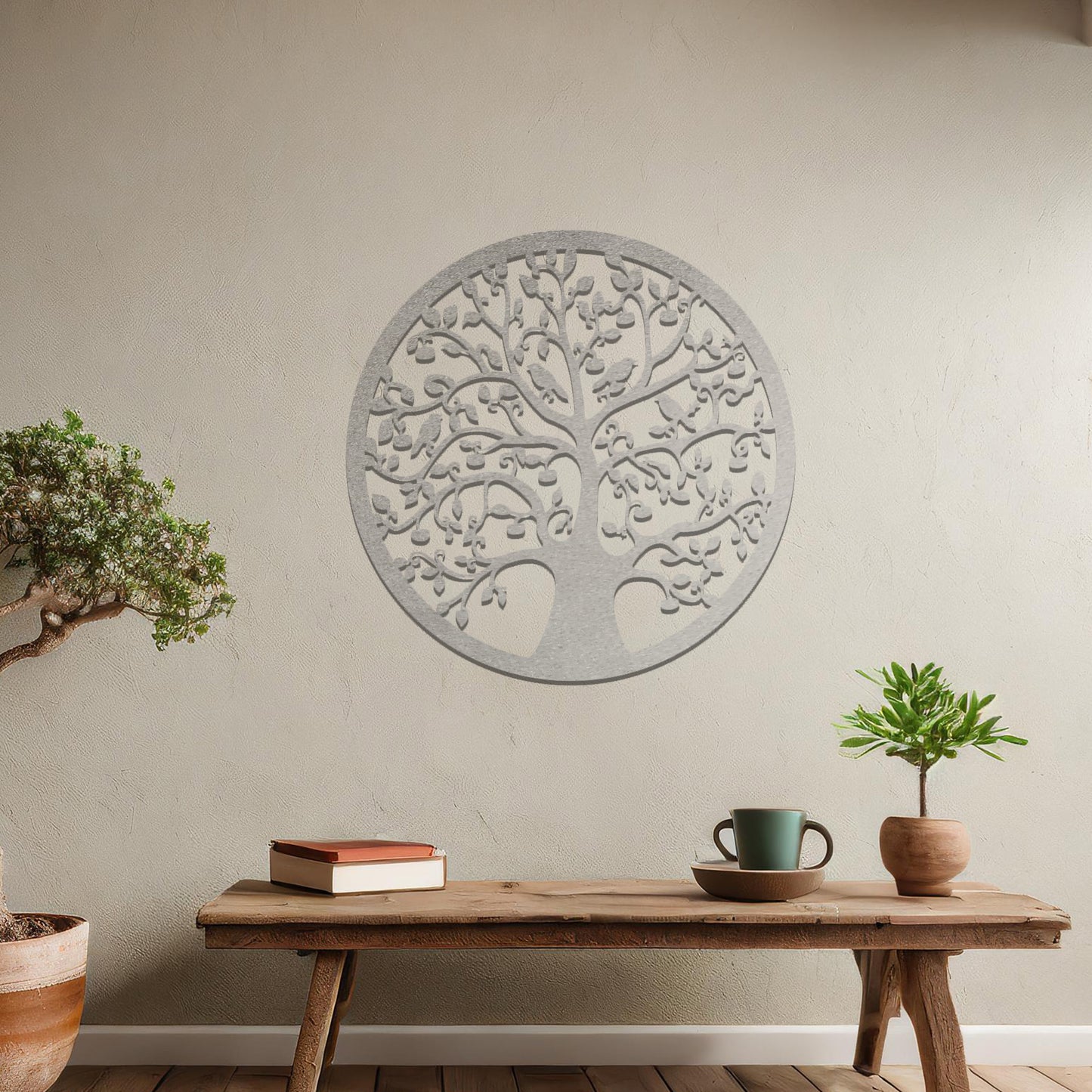 Metal wall art featuring a circular tree design with intricate branches and leaves, showcasing a detailed and balanced composition, displayed on a neutral wall within modern decor.
