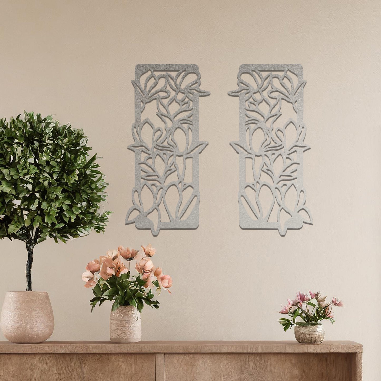 Metal wall art featuring a pair of vertical panels with floral-inspired designs of intertwined stems and leaves, crafted with precise laser-cut detailing, displayed on a neutral wall within modern decor.