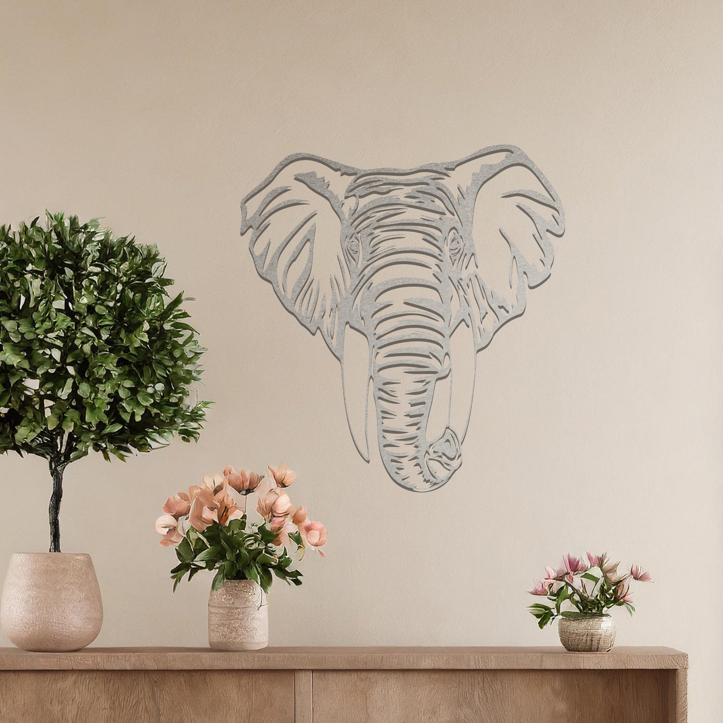 Metal wall art featuring a detailed elephant head design with intricate lines and realistic features, crafted with precise laser-cut techniques, displayed on a neutral wall within modern decor.