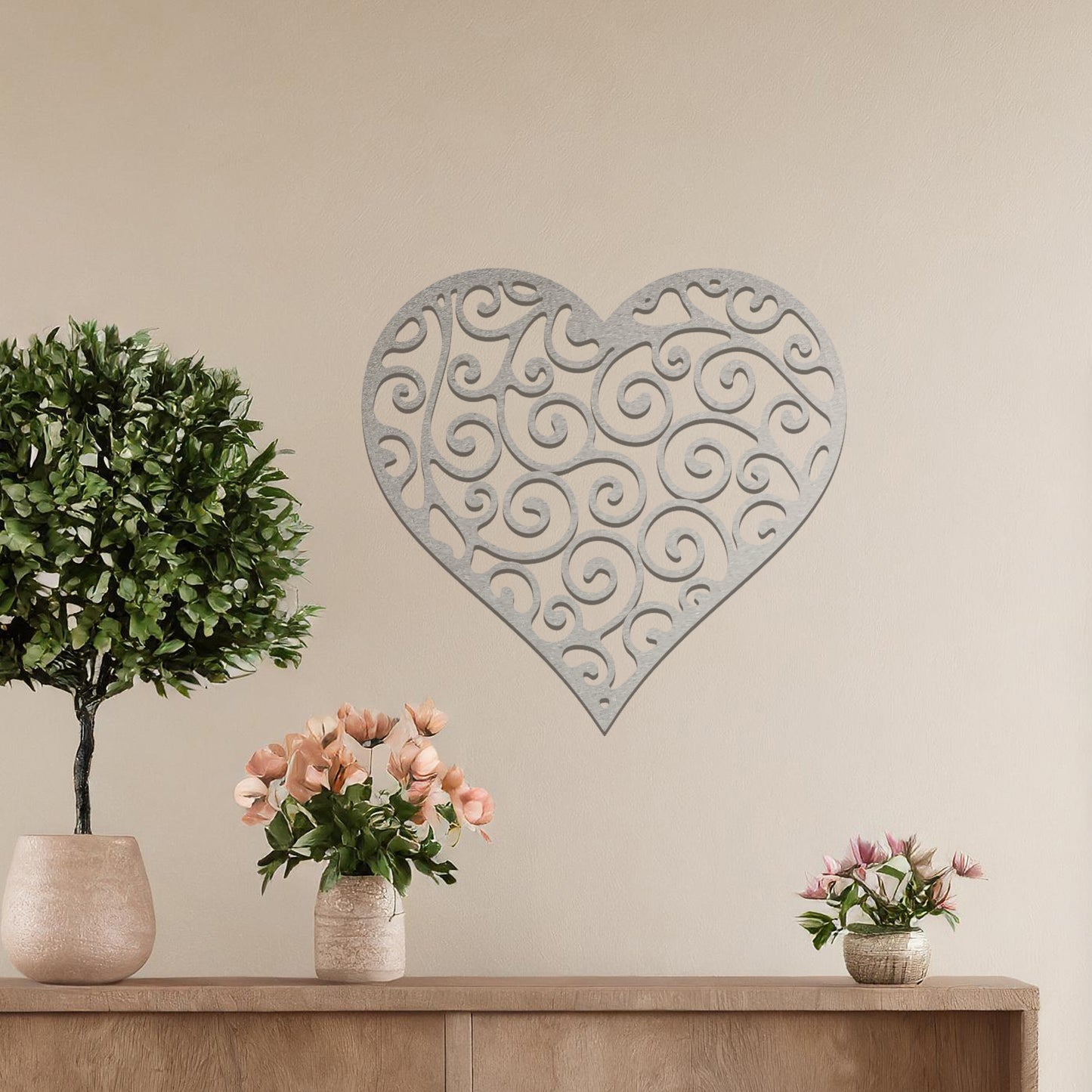 Metal wall art featuring a heart-shaped design with intricate swirling patterns, adding an elegant and romantic touch to the room’s decor.