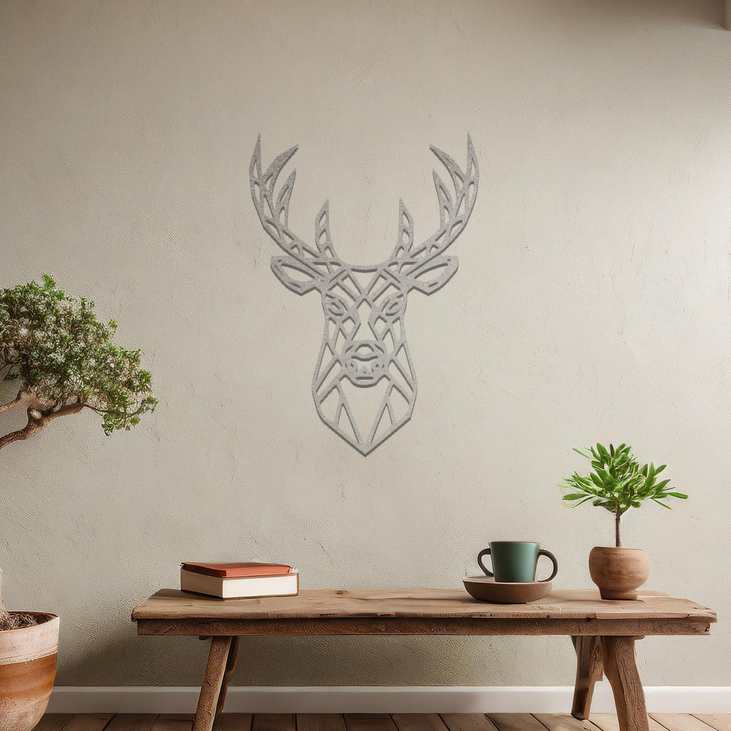 Metal wall art featuring a geometric deer head design with intricate detailing, crafted with precise laser-cut techniques, displayed on a neutral wall within modern decor.