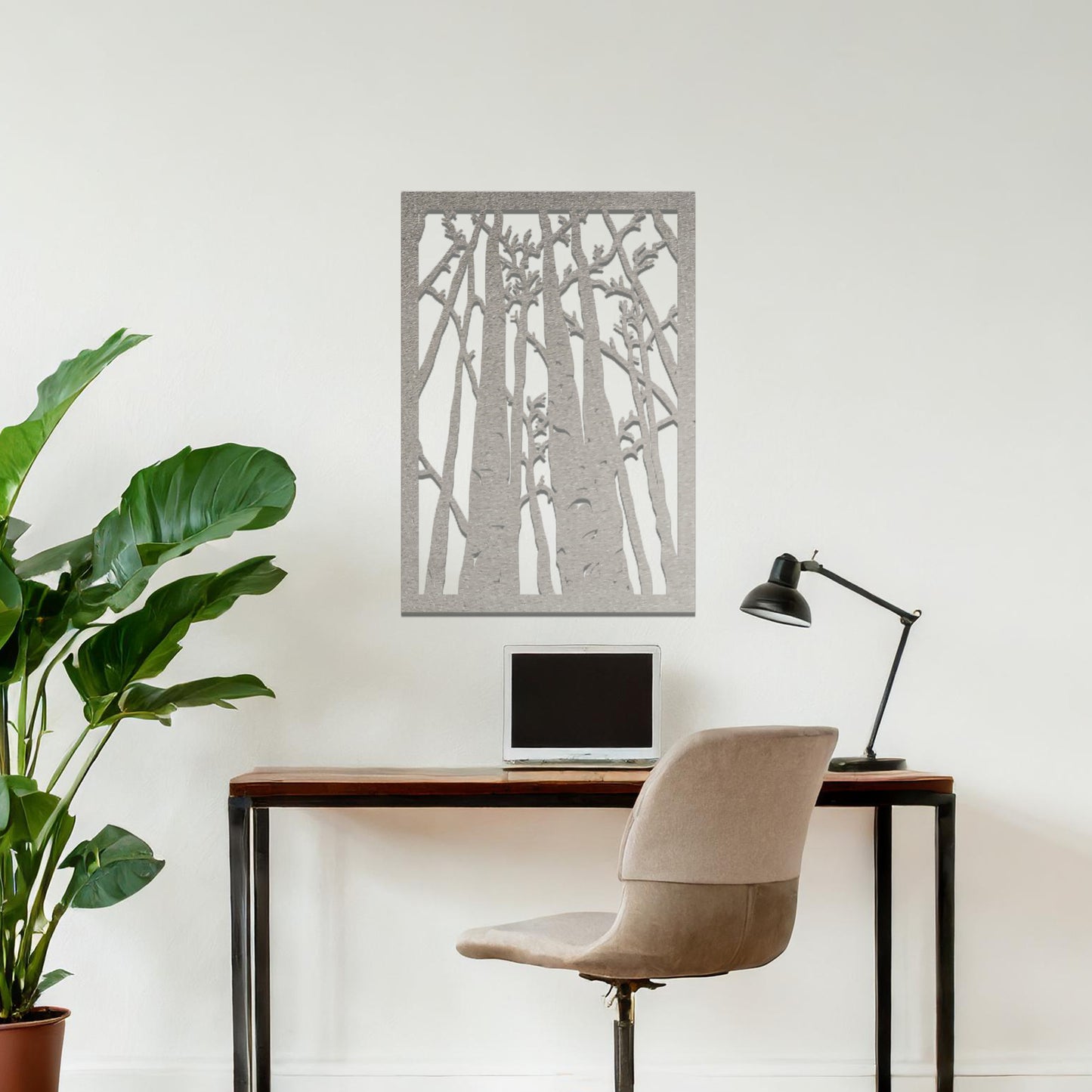 Metal wall art featuring a rectangular design of tall trees with bare branches, showcasing intricate details, displayed on a neutral wall within modern decor.