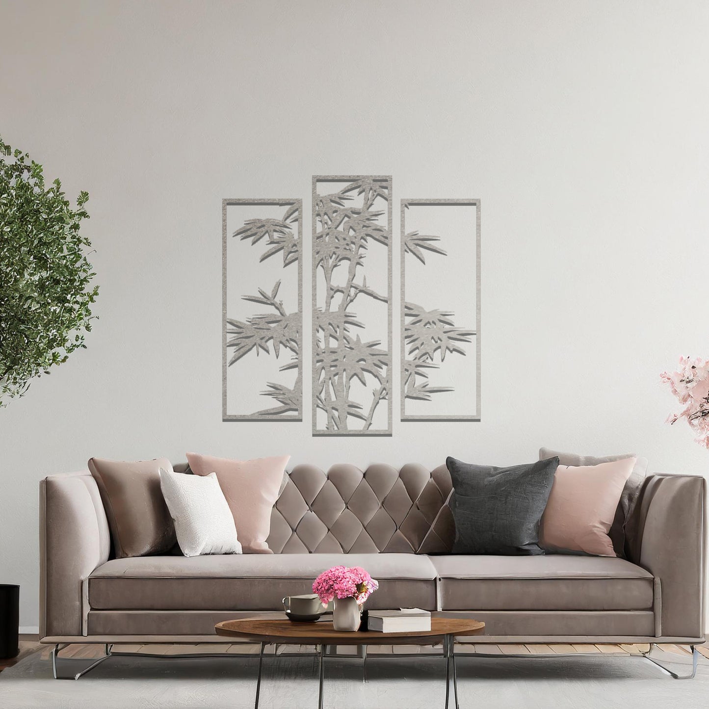 Metal wall art featuring a three-panel bamboo design with intricate leaves and stems, crafted with precise laser-cut detailing, displayed on a neutral wall within modern decor.